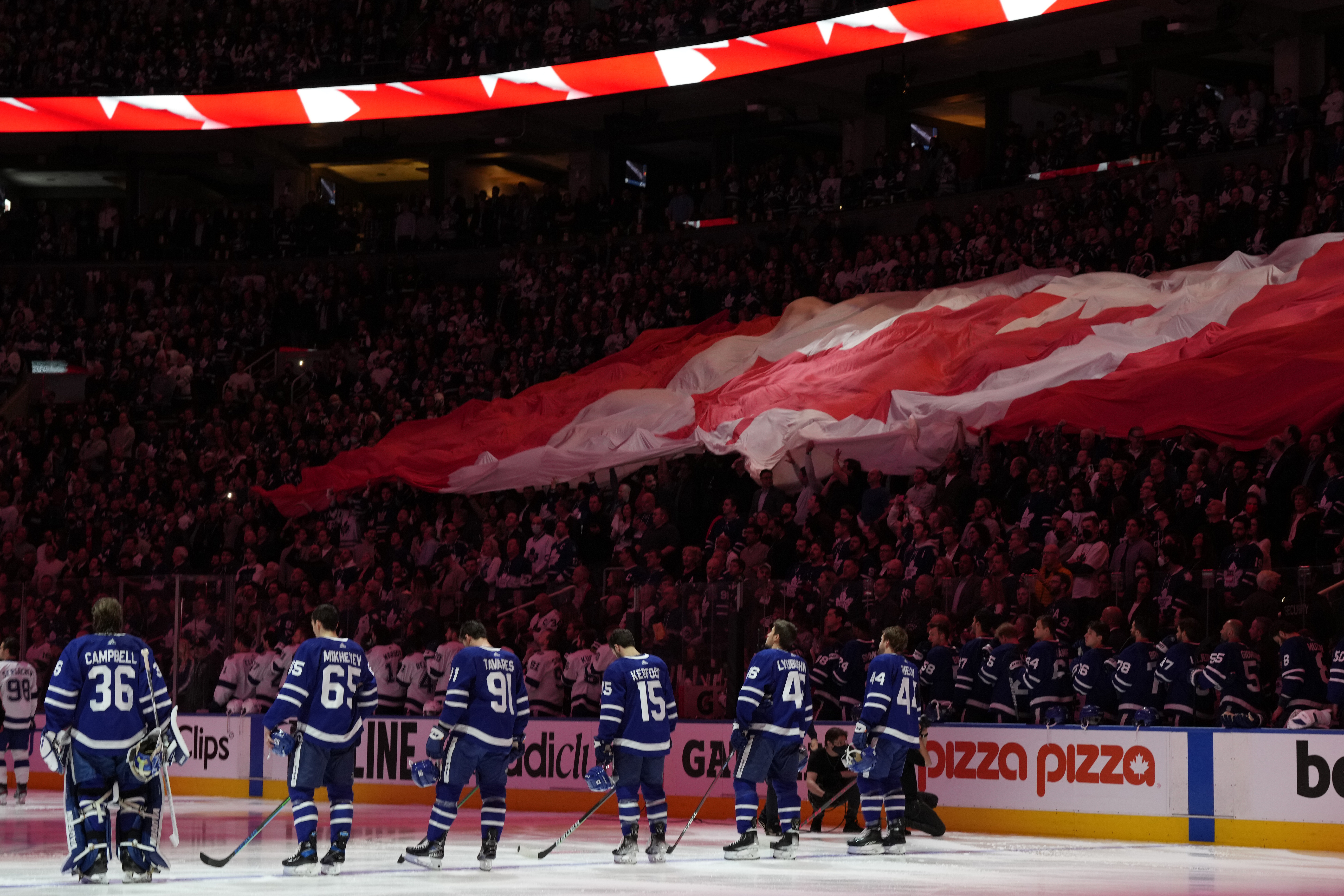 Fans and players stand for the national anthems before Game 2 of an NHL hockey Stanley Cup playoffs first-round series between the Tampa Bay Lightning and the Toronto Maple Leafs on Wednesday, May 4, 2022, in Toronto. 