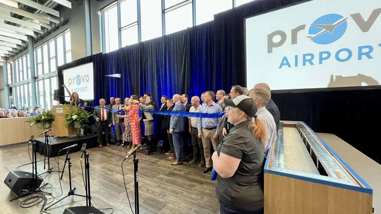 Provo Mayor Michelle Kaufusi cuts a ribbon inside the new Provo City Airport terminal Friday to celebrate the grand opening of the terminal, which will begin service this summer.