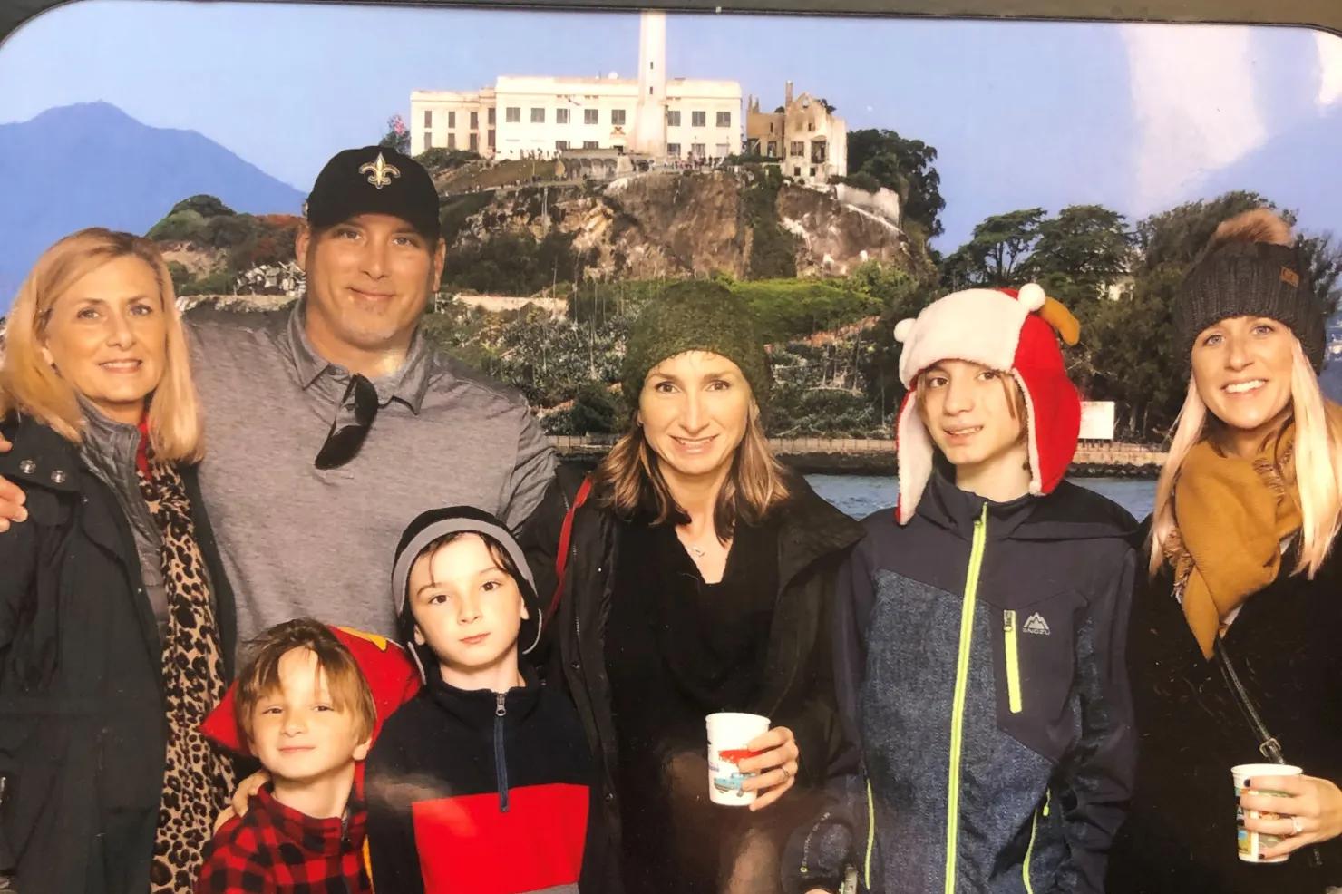 Matthew Robertson with his biological mother, Judy Lloyd, left, his wife and children and his sister, Lauren Chapman, far right, with Alcatraz in the San Francisco Bay, California, in the background.