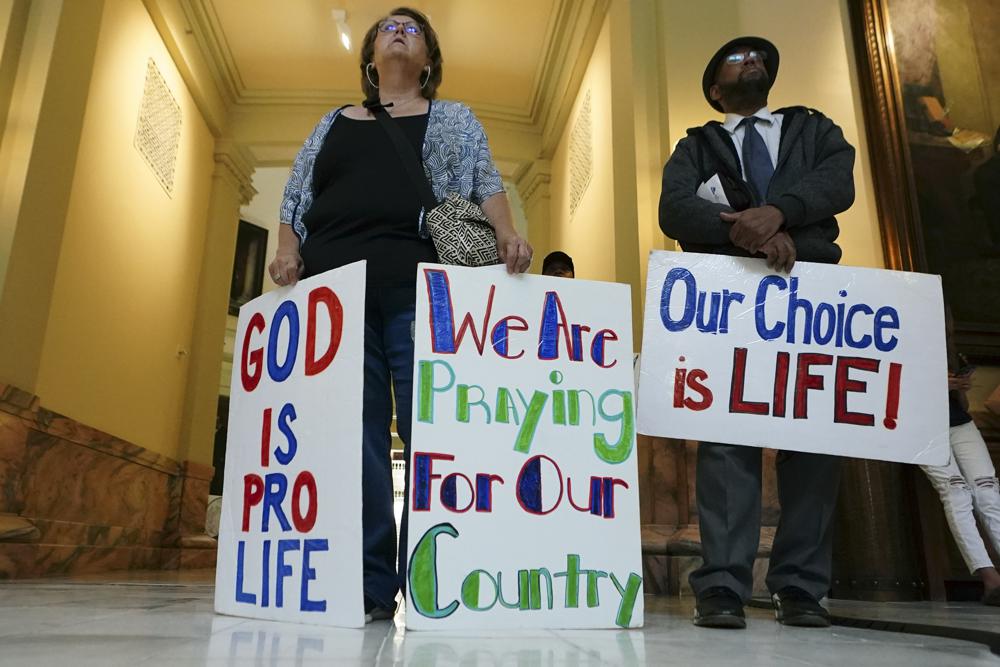 Donna Boyer, of Smyrna, Ga., and Brian Lawton, of Atlanta, listen to a speaker during a small rally against abortion inside the Georgia State Capitol Friday, in Atlanta. Pres. Joe Biden is facing his limited power to enact policies promised before the election.