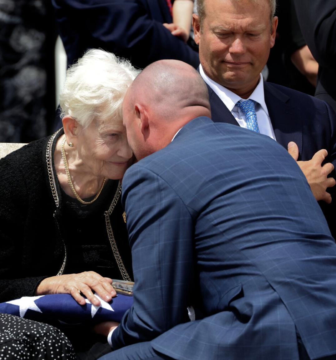 Elaine Hatch, wife of former U.S. Sen. Orrin G. Hatch, speaks with Gov. Spencer Cox as he gives her the flag that was draped over her husband's casket as the Hatches' son Jess looks on after the funeral service at The Church of Jesus Christ of Latter-day Saints' Institute of Religion adjacent to the University of Utah in Salt Lake City on Friday.