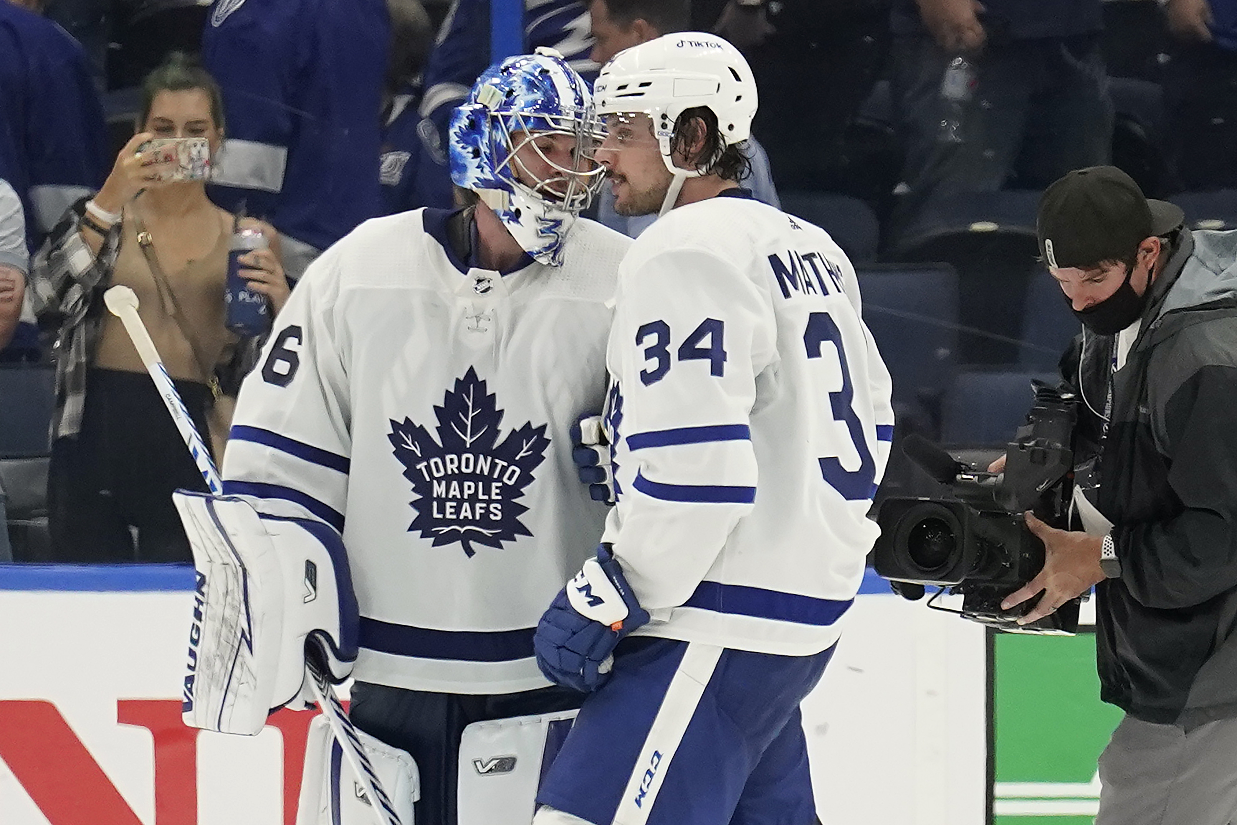 Toronto Maple Leafs goaltender Jack Campbell (36) and center Auston Matthews (34) celebrate after the team defeated the Tampa Bay Lightning during Game 3 of an NHL hockey first-round playoff series Friday, May 6, 2022, in Tampa, Fla. 