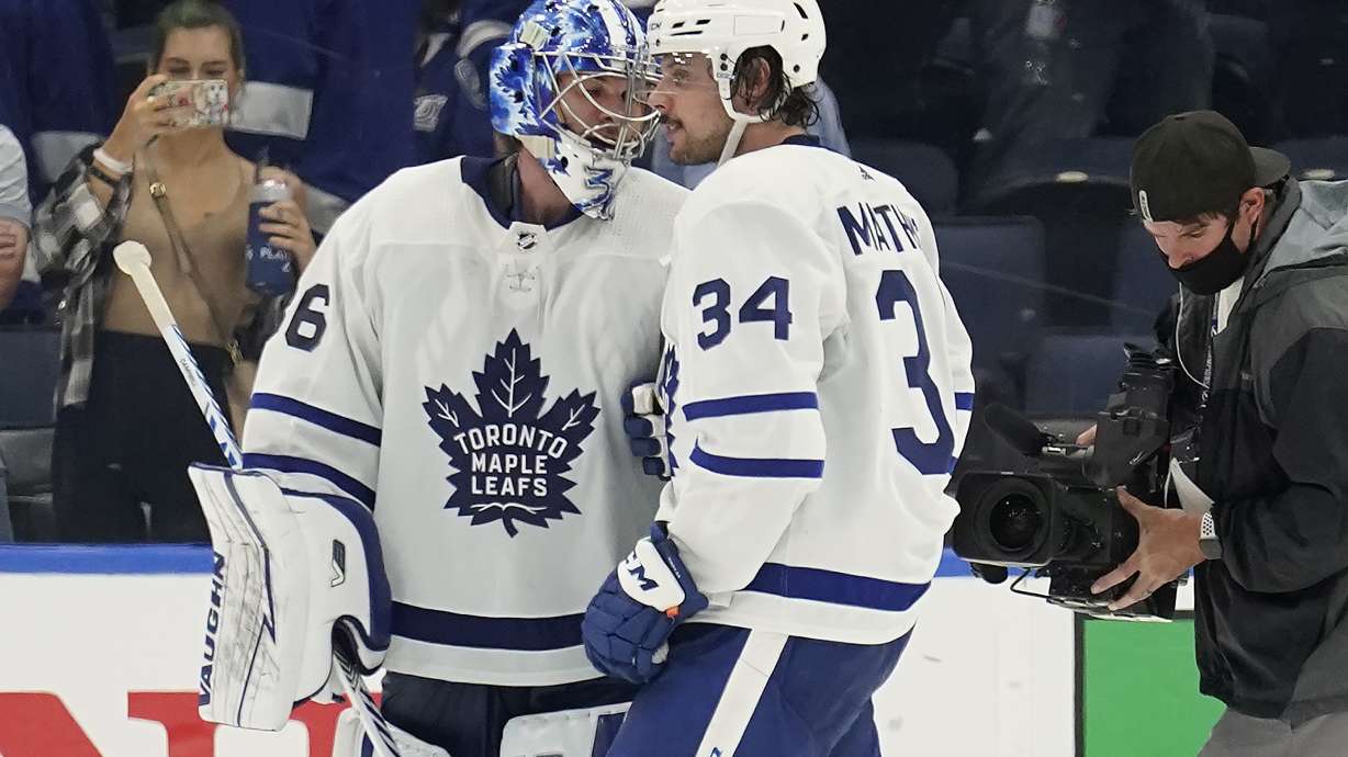 Toronto Maple Leafs goaltender Jack Campbell (36) and center Auston Matthews (34) celebrate after the team defeated the Tampa Bay Lightning during Game 3 of an NHL hockey first-round playoff series Friday, May 6, 2022, in Tampa, Fla.