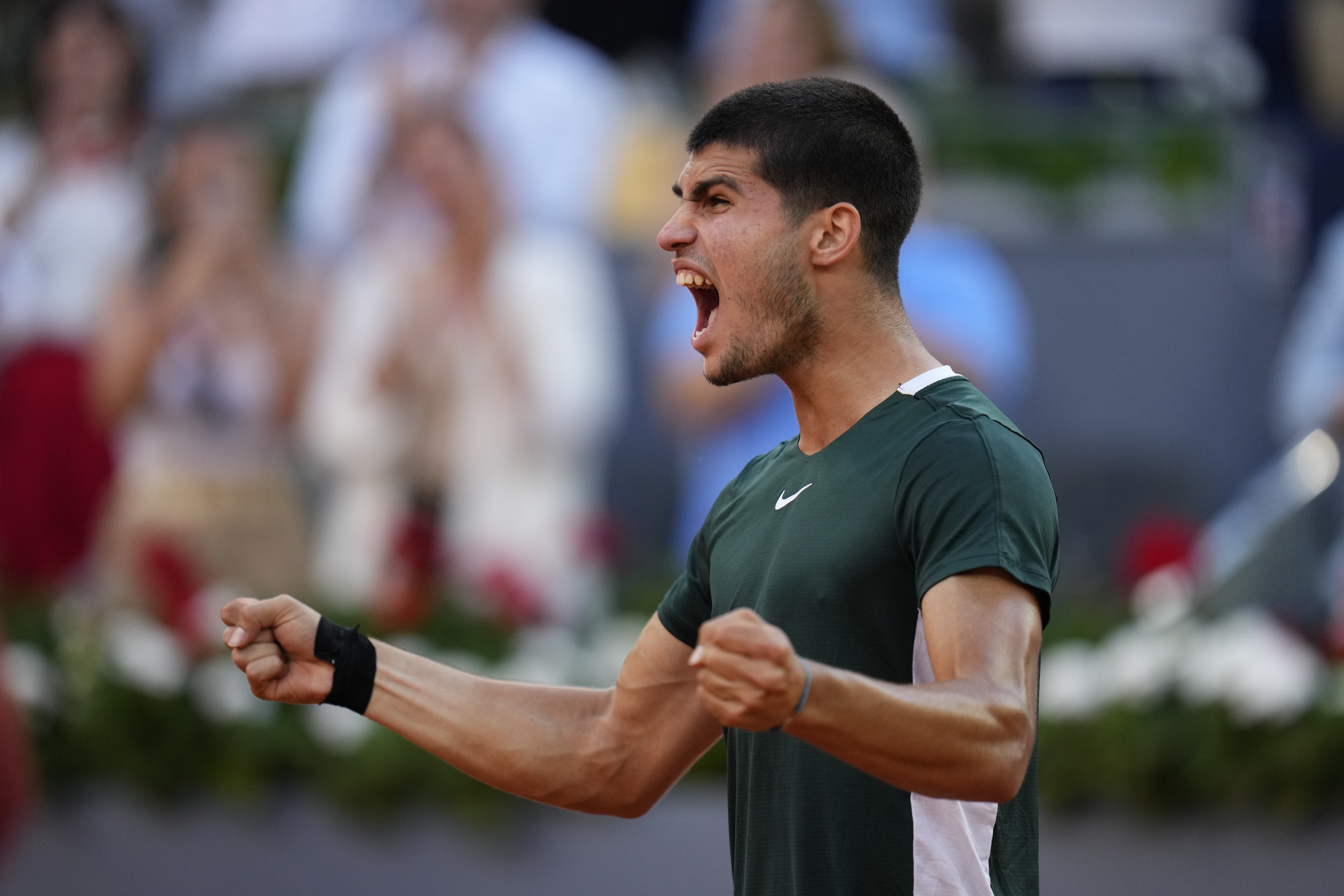 Carlos Alcaraz celebrates after defeating Novak Djokovic during a men's semifinal at the Mutua Madrid Open tennis tournament in Madrid, Spain, Saturday, May 7, 2022. 