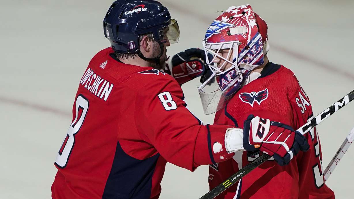 Washington Capitals left wing Alex Ovechkin and goaltender Ilya Samsonov embrace after Game 3 in the first-round of the NHL Stanley Cup hockey playoffs, Saturday, May 7, 2022, in Washington. The Capitals won 6-1.