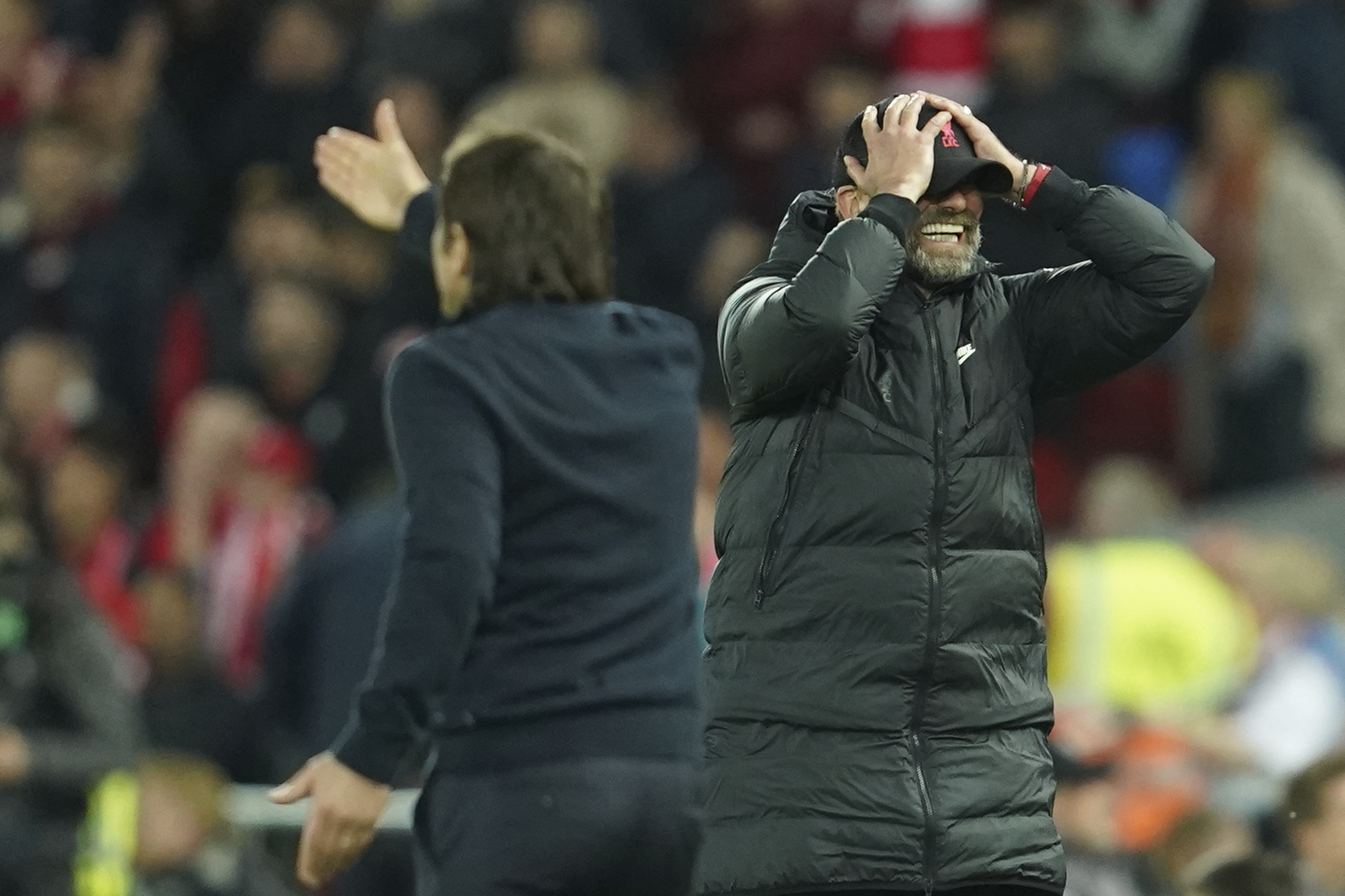 Liverpool's manager Jurgen Klopp, right, gestures during the English Premier League soccer match between Liverpool and Tottenham Hotspur at Anfield stadium in Liverpool, England, Saturday, May 7, 2022.