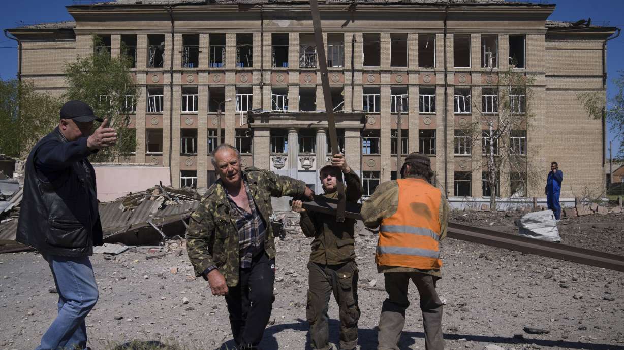 People clean an area after Russian airstrike in Kostyantynivka, Donetsk region, Ukraine, Saturday.
