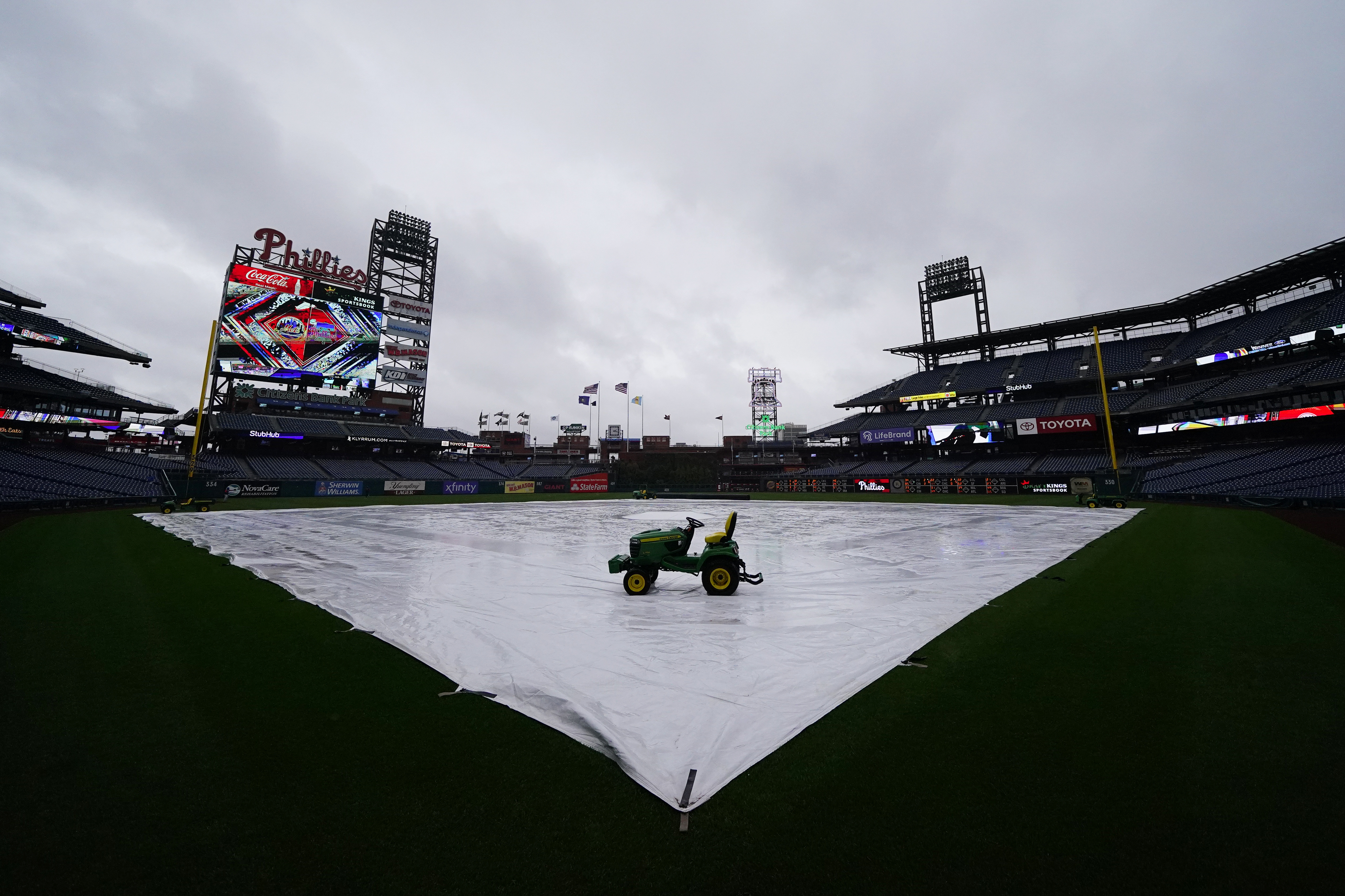 A tarp is seen covering the field as a storm postpones a baseball game between the Philadelphia Phillies and the New York Mets, Saturday, May 7, 2022, in Philadelphia. 