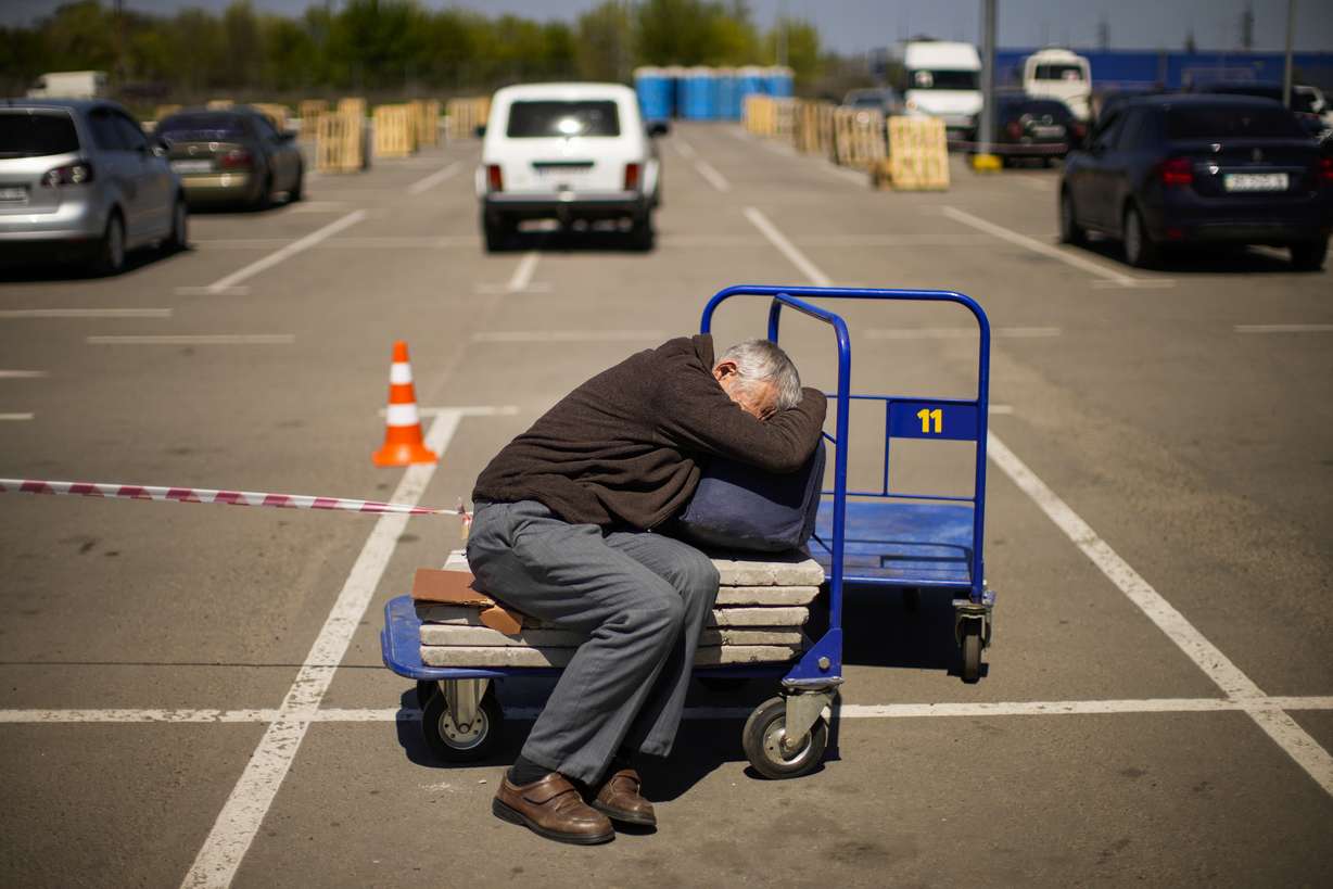 A man who fled from a small village near Polohy rests upon his arrival to a reception center for displaced people in Zaporizhzhia, Ukraine, Sunday. Thousands of Ukrainian continue to leave Russian occupied areas.