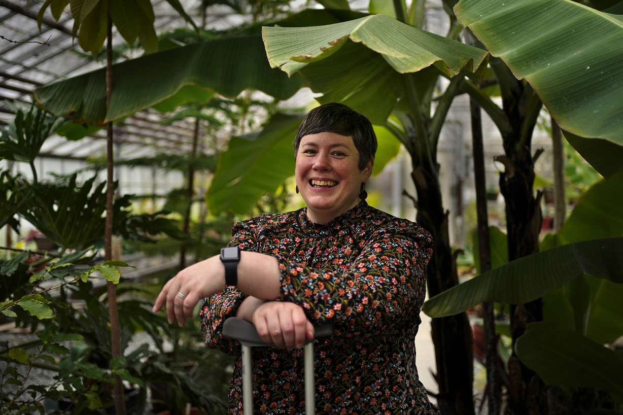 University of Maine climatologist Jacquelyn Gill poses in one of the school's greenhouses Wednesday in Orono, Maine. While most climate change news is grim, many scientists like Gill have found ways to stay optimistic about the future.