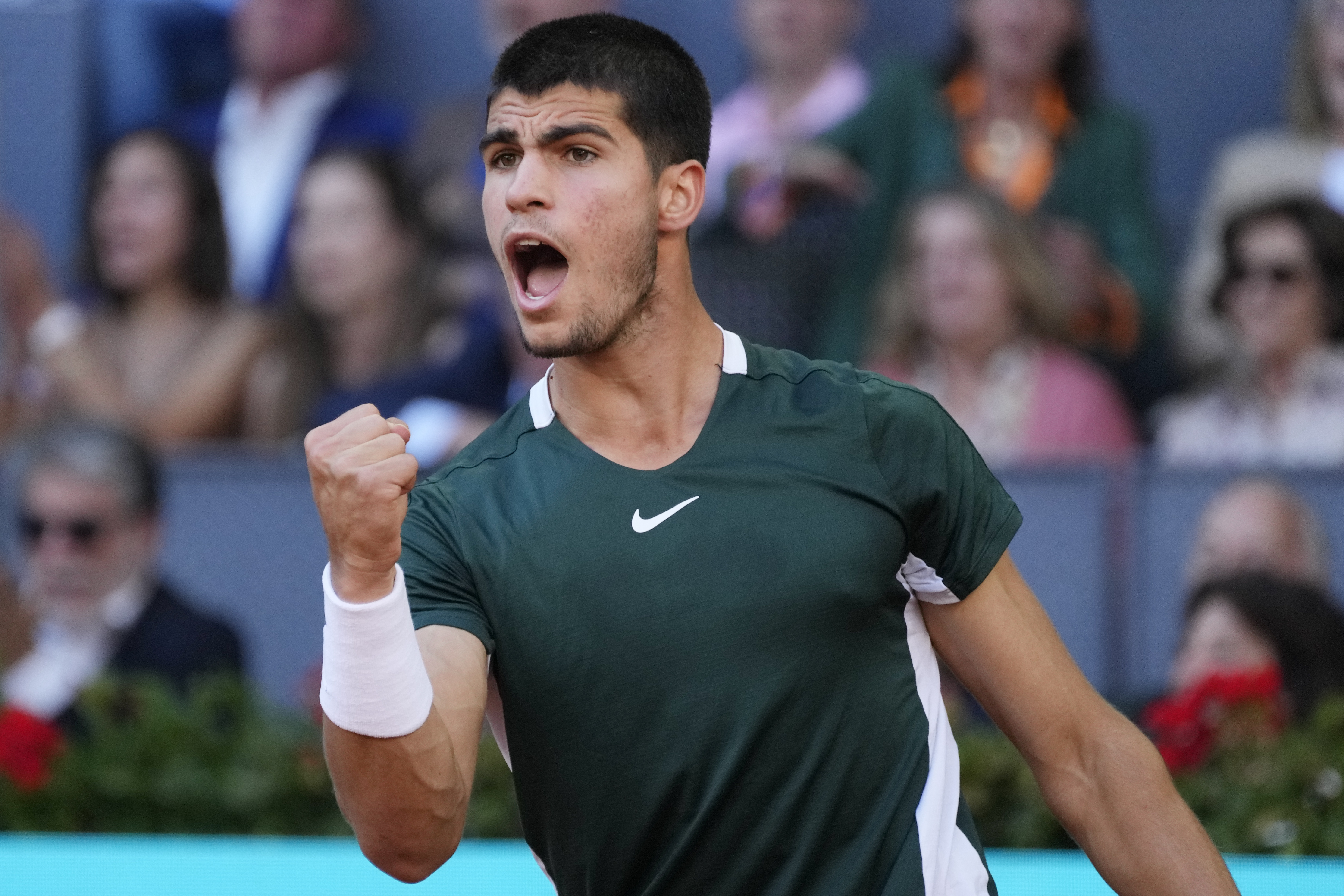 Carlos Alcaraz, of Spain, celebrates after winning a point during the final match with Alexander Zverev, of Germany, at the Mutua Madrid Open tennis tournament in Madrid, Spain, Sunday, May 8, 2022.