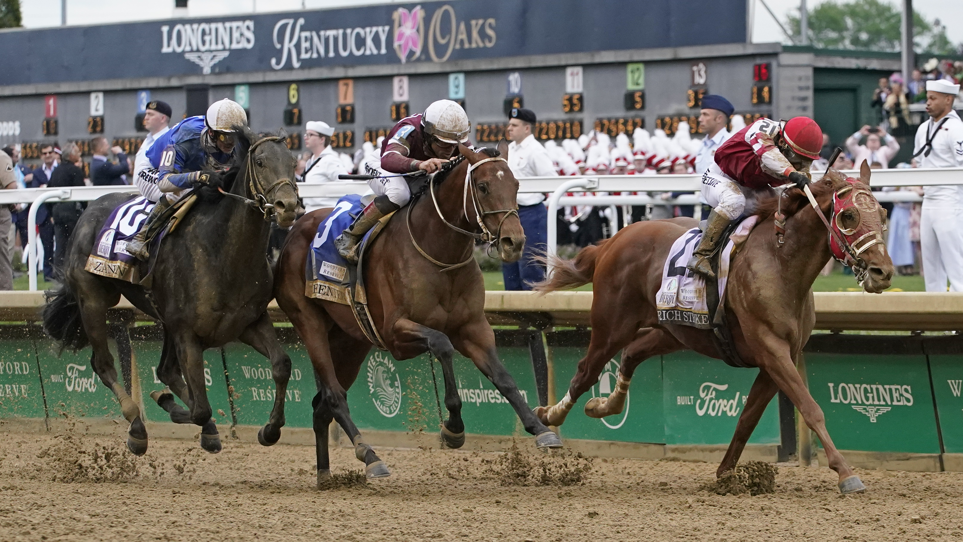 Rich Strike (21), with Sonny Leon aboard, leads Epicenter (3), with Joel Rosario aboard, and Zandon (10), with Flavien Prat aboard, down the straightaway to win the 148th running of the Kentucky Derby horse race at Churchill Downs Saturday, May 7, 2022, in Louisville, Ky.