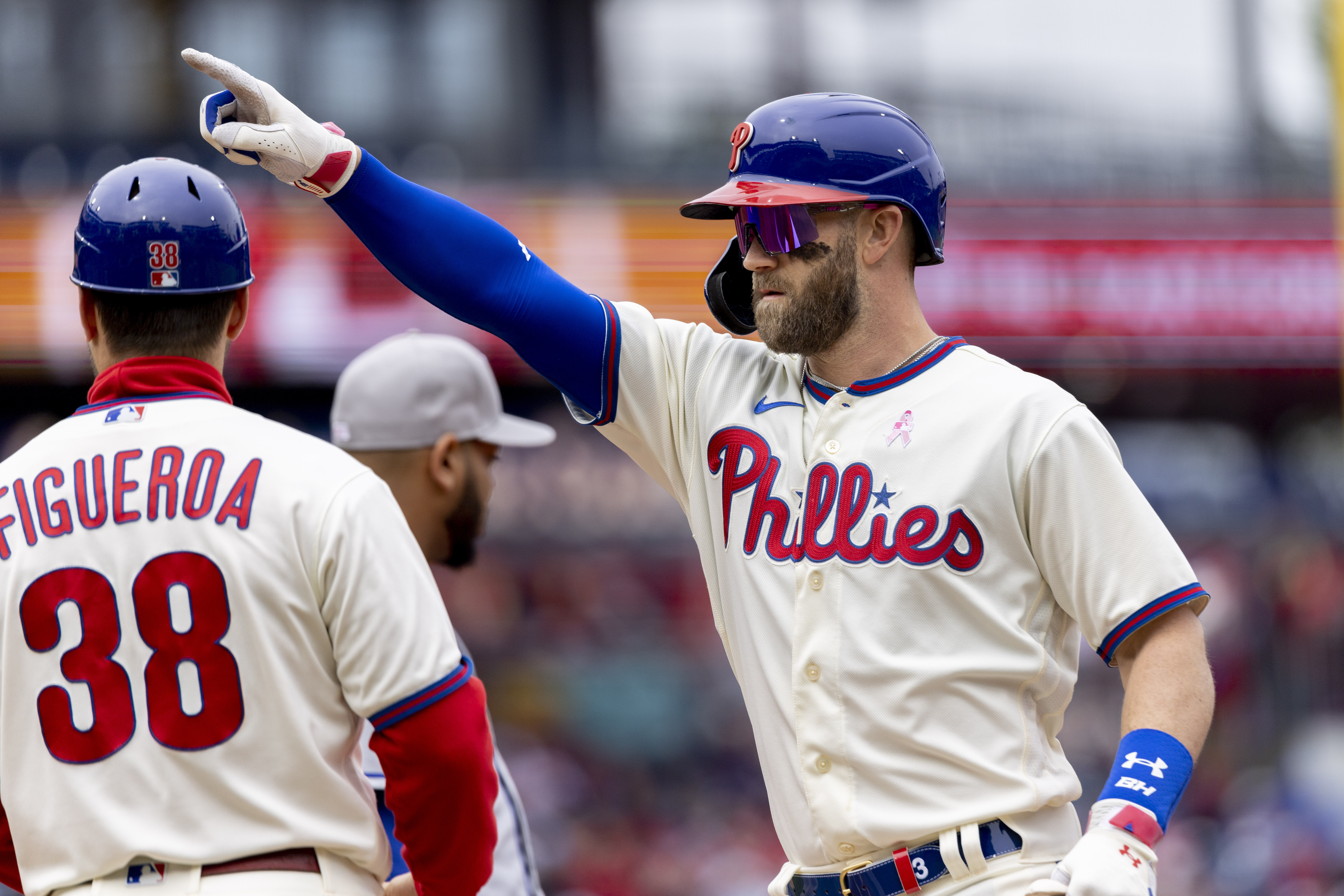 Philadelphia Phillies' Bryce Harper (3) gestures from first base after hitting an RBI single during the third inning of the first game of a double header against the New York Mets, Sunday, May 8, 2022, in Philadelphia. 