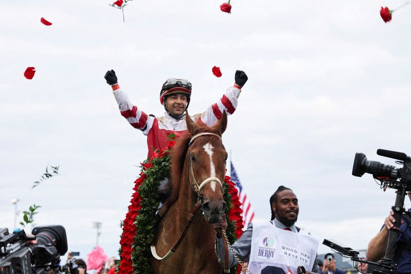 FILE PHOTO: Jockey Sonny Leon throws roses in celebration after the win of Rich Strike at the 148th Kentucky Derby, at Churchill Downs in Louisville, Kentucky, U.S. May 7, 2022.
