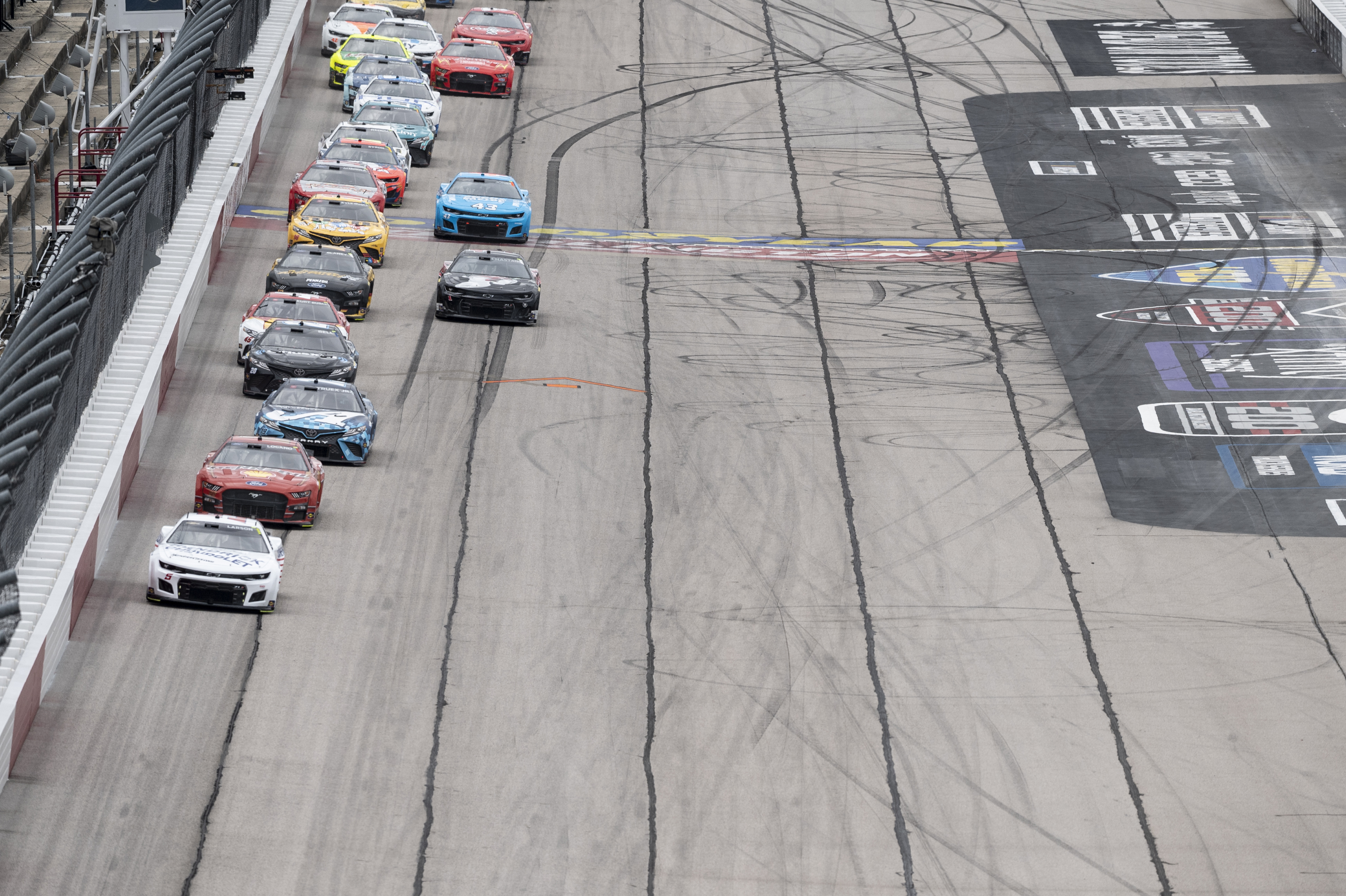 Kyle Larson (5) leads a pack of cars down the front stretch during a NASCAR Cup Series auto race at Darlington Raceway, Sunday, May 8, 2022, in Darlington, S.C. 