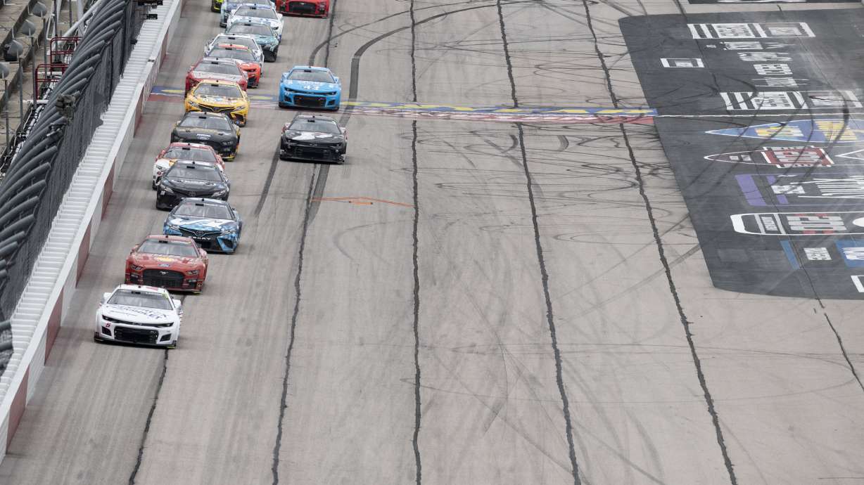 Kyle Larson (5) leads a pack of cars down the front stretch during a NASCAR Cup Series auto race at Darlington Raceway, Sunday, May 8, 2022, in Darlington, S.C.