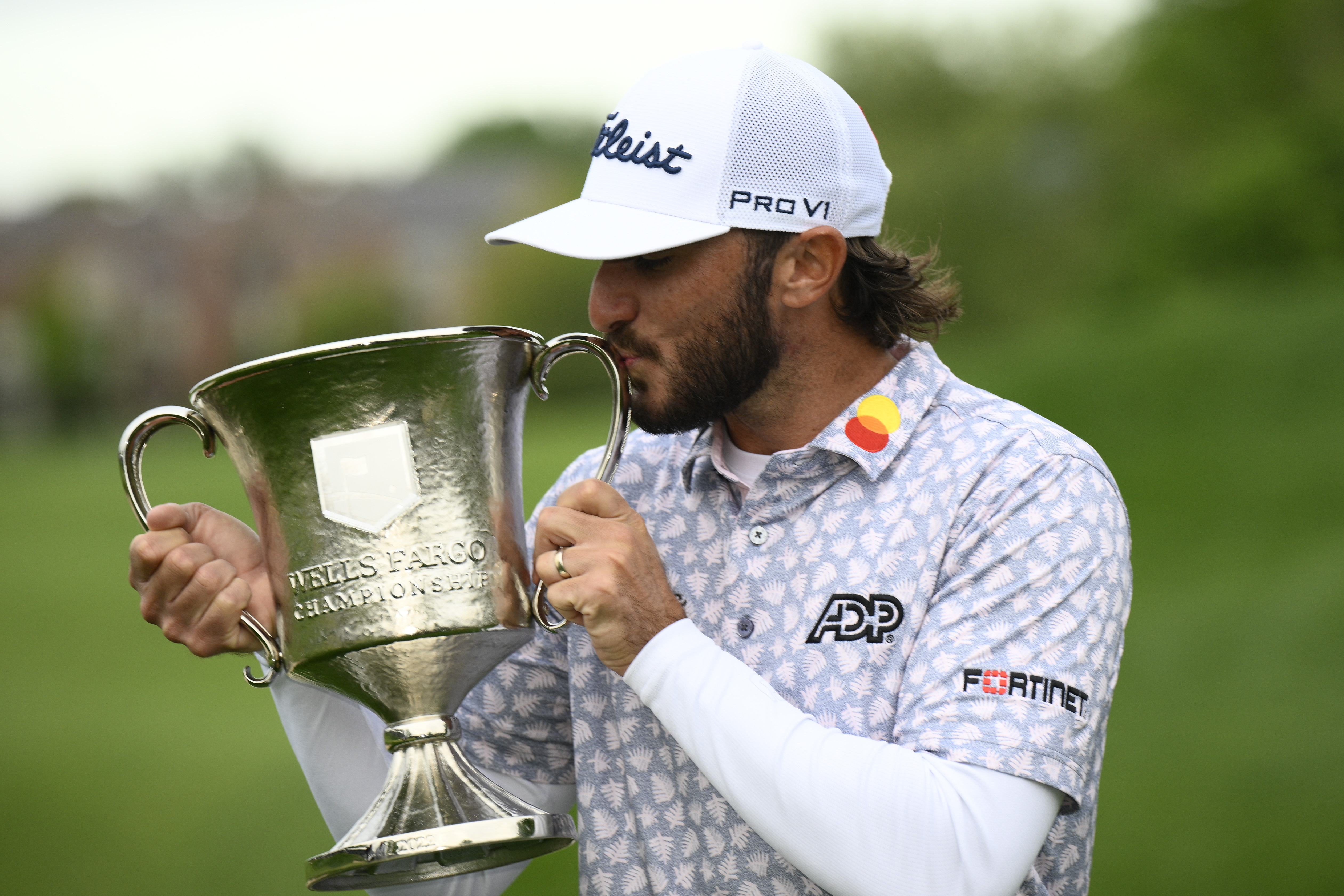 Max Homa kisses the trophy after winning the Wells Fargo Championship golf tournament, Sunday, May 8, 2022, at TPC Potomac at Avenel Farm golf club in Potomac, Md. 