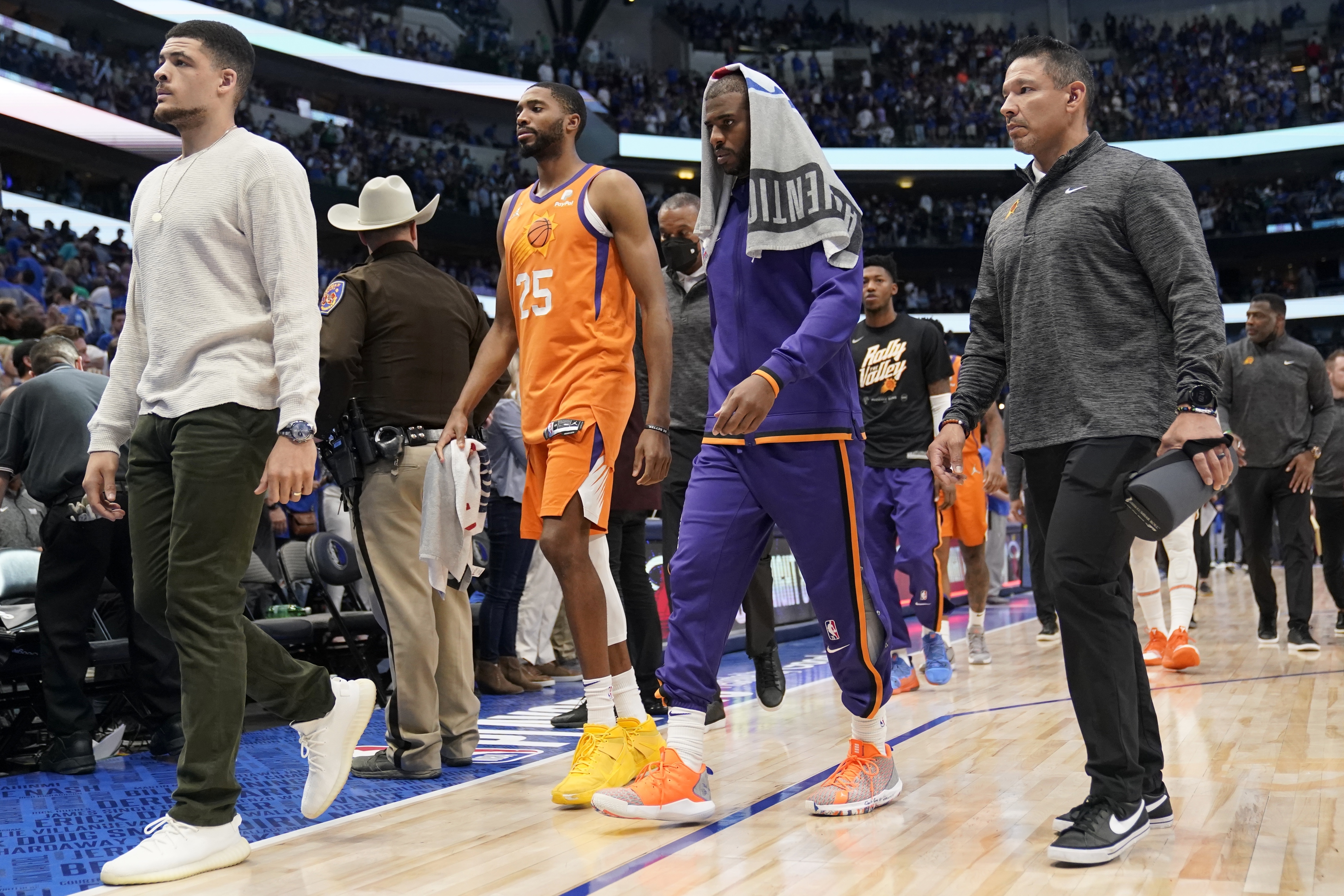 Phoenix Suns forward Mikal Bridges (25) and guard Chris Paul, second from right, walk off the court after Game 4 of an NBA basketball second-round playoff series against the Dallas Mavericks, Sunday, May 8, 2022, in Dallas. 