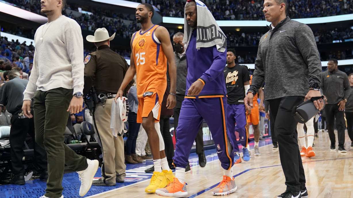 Phoenix Suns forward Mikal Bridges (25) and guard Chris Paul, second from right, walk off the court after Game 4 of an NBA basketball second-round playoff series against the Dallas Mavericks, Sunday, May 8, 2022, in Dallas.