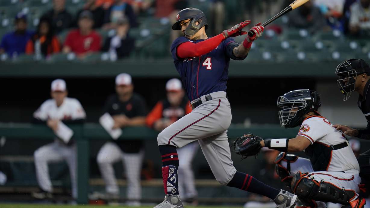 Minnesota Twins' Carlos Correa follows through on a swing against the Baltimore Orioles during the first inning of a baseball game, Thursday, May 5, 2022, in Baltimore.