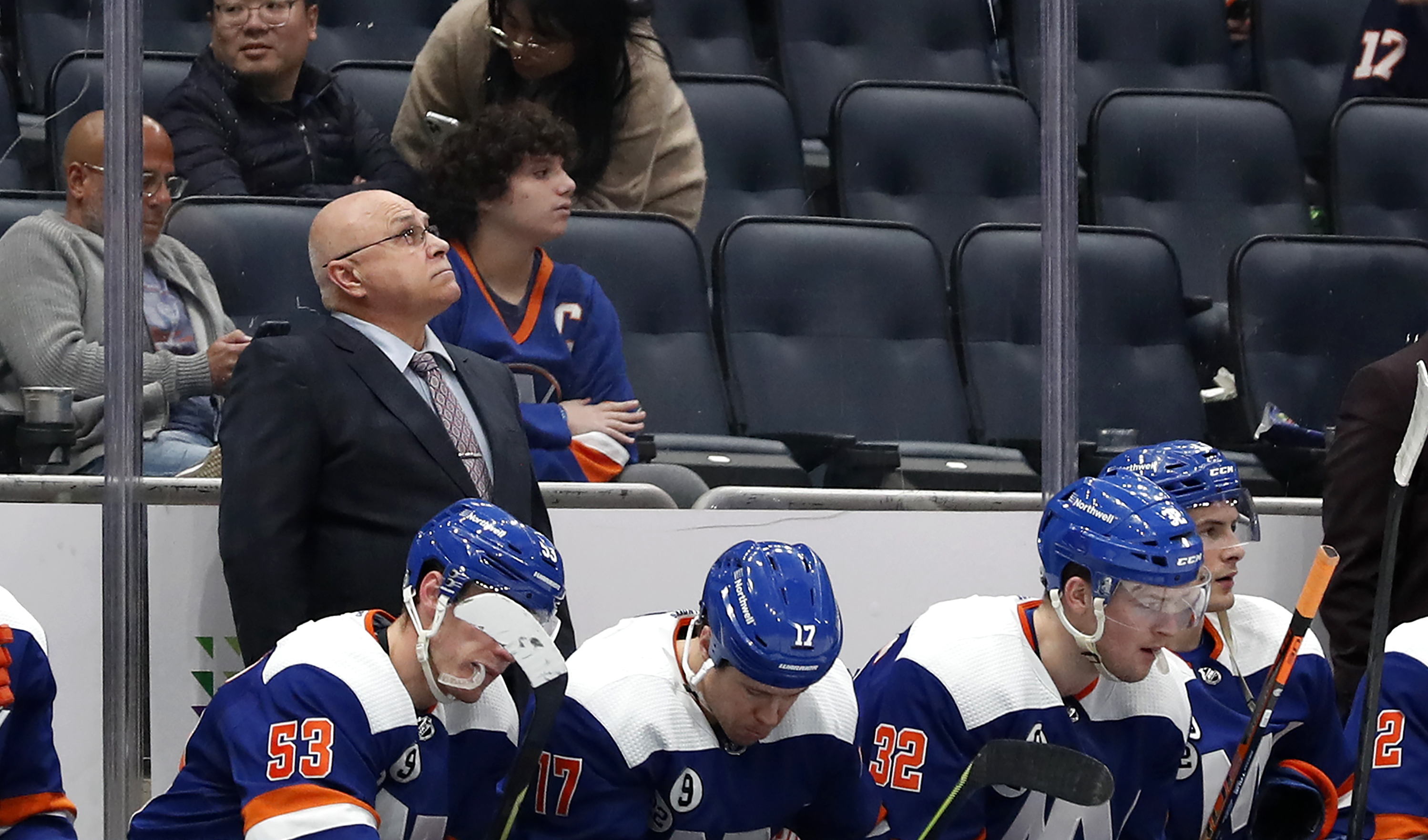 New York Islanders head coach Barry Trotz looks at the score board after the Carolina Hurricanes scored two empty net goals during the third period of an NHL hockey game, Sunday, Apr. 24, 2022, in New York.