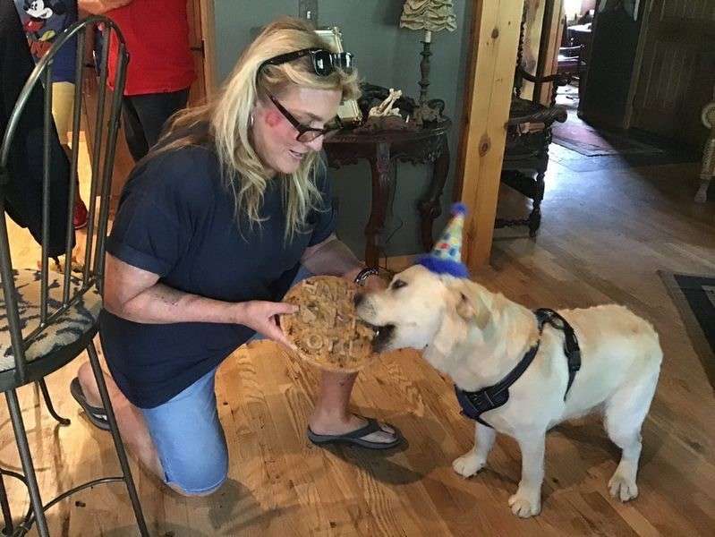 Lisa Anderson of Park City is pictured with a dog. She was shocked when a test highlighted major metal toxins in the water at her Park City home, although Park City water was safe to use.