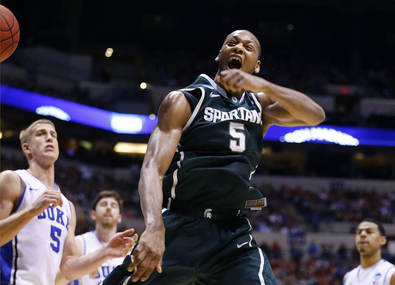 FILE PHOTO: Michigan State Spartans forward Adreian Payne (5) celebrates a slam dunk against the Duke Blue Devils during their Midwest Regional NCAA men's basketball game in Indianapolis, Indiana, March 29, 2013.