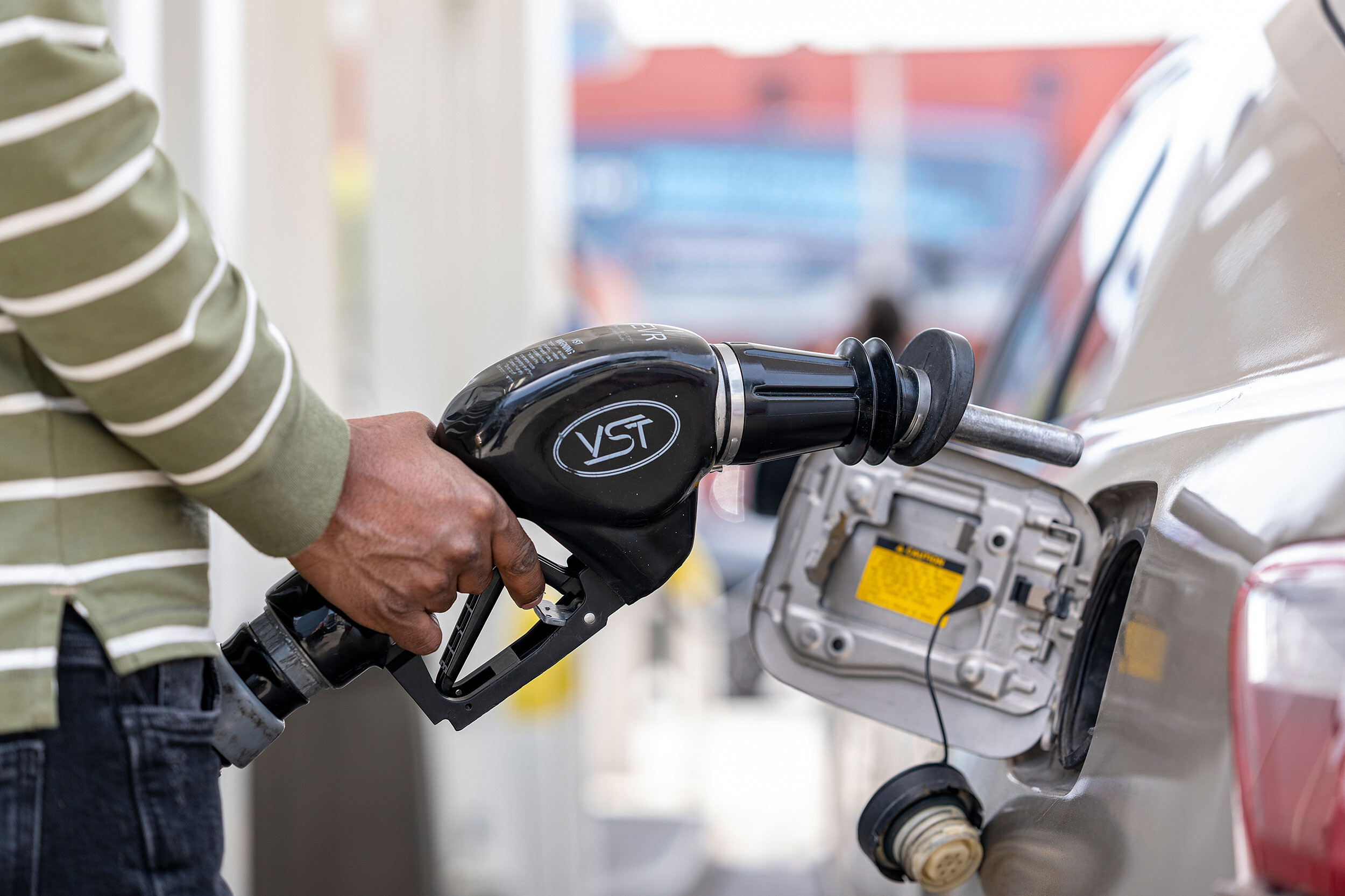 A customer holds a fuel nozzle at a gas station in San Francisco on April 27. According to AAA, the national average for regular gasoline has risen to $4.328 a gallon.