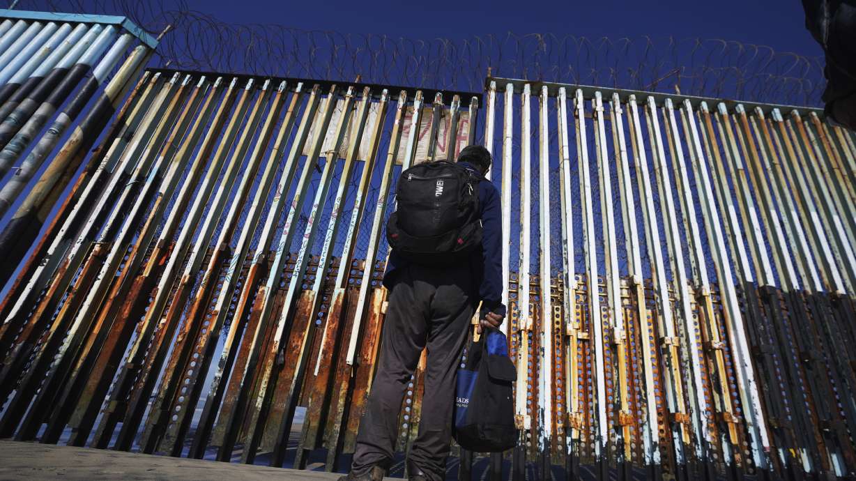 A migrant waits on the Mexican side of the border after United States Customs and Border Protection officers detained a couple of migrants crossing the US-Mexico border on the beach, in Tijuana, Mexico, Jan. 26. About 3 in 10 people worry that more immigration can cause native-born Americans to lose their economic, political and cultural influence, according to a poll by The Associated Press-NORC Center for Public Affairs Research.