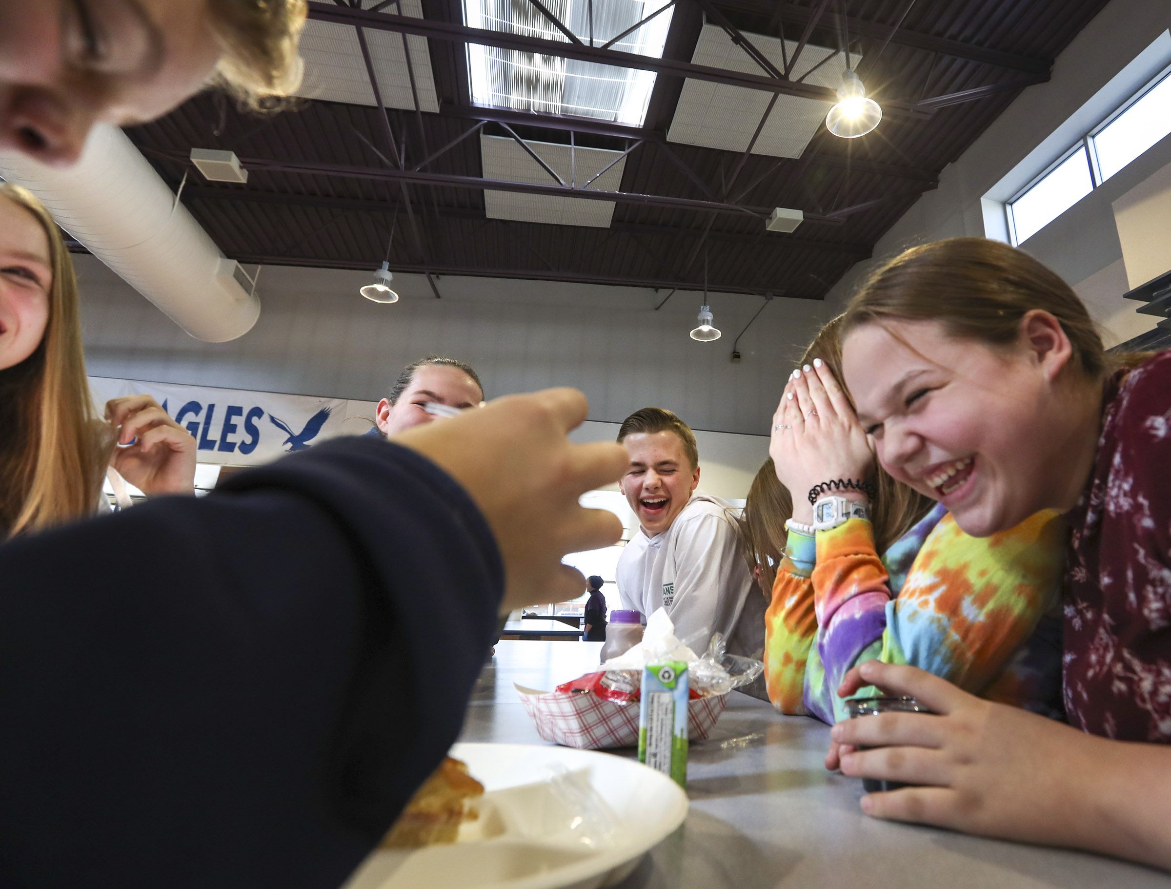 Bountiful Junior High School students laugh as they eat lunch at the school cafeteria on Feb. 19, 2020, in Bountiful. Free school lunches and breakfasts offered to all students in eligible schools for the past two years will come to an end at the end of the school year.