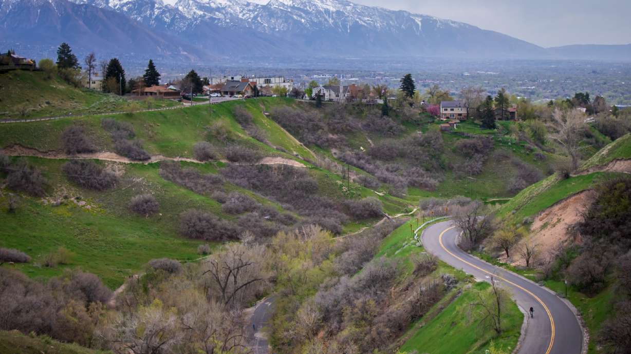 A cyclist rides through Bonneville Boulevard near the mouth of City Creek Canyon during a cloudy spring evening in Salt Lake City on April 27. Storms in March, April and May have produced rain and snow across the state, but not enough to match spring normals.