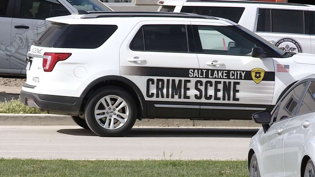 A Salt Lake City police vehicle is parked outside a building under construction near 2300 North and 2200 West in Salt Lake City where a worker died in an accident on Monday.