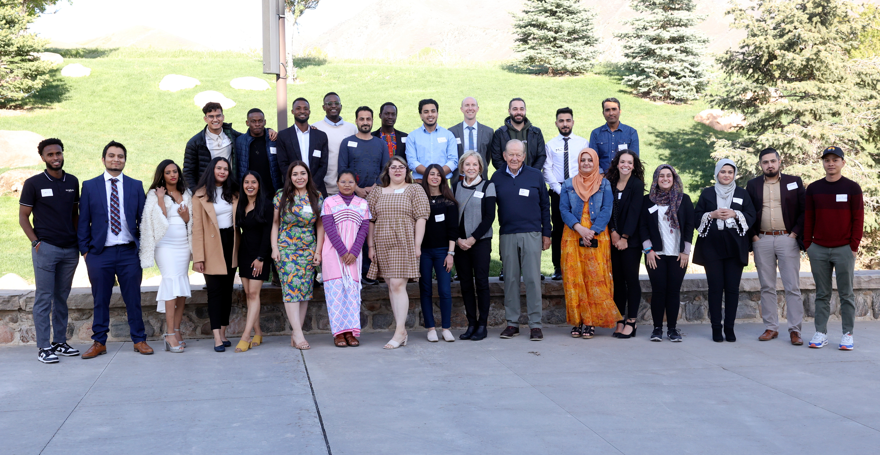 One Refugee graduates pose for a group photo with the One Refugee founders and executive director during the One Refugee Annual Celebration, to honor the 64 college graduates who are also refugees, at The Garden Place in Salt Lake City, on Monday.
