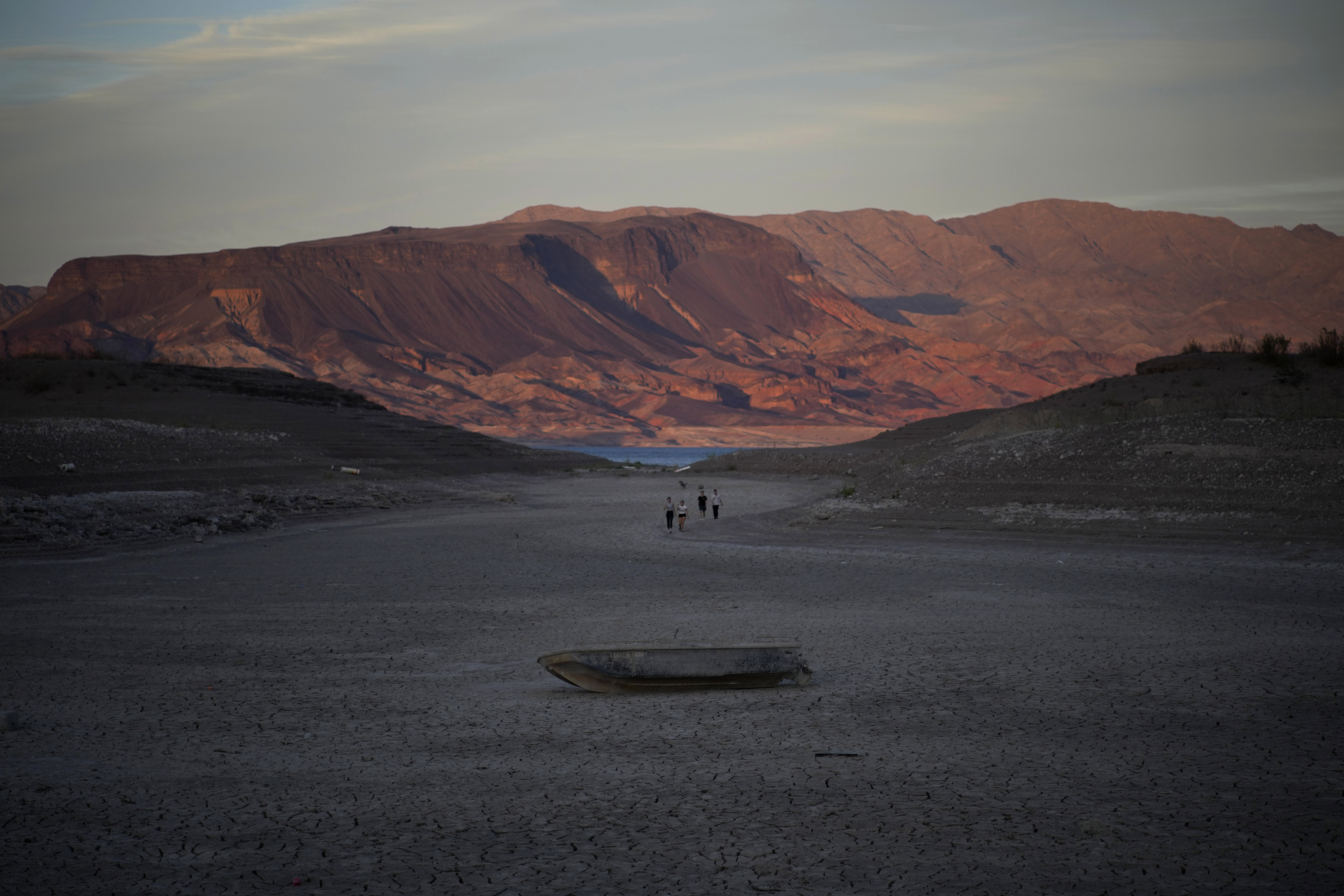 A formerly sunken boat sits on cracked earth hundreds of feet from what is now the shoreline on Lake Mead at the Lake Mead National Recreation Area, Monday, near Boulder City, Nev. Lake Mead is receding and Sin City is awash with mob lore after a second set of human remains emerged within a week from the depths of the drought-stricken Colorado River reservoir just a short drive from the Las Vegas Strip.