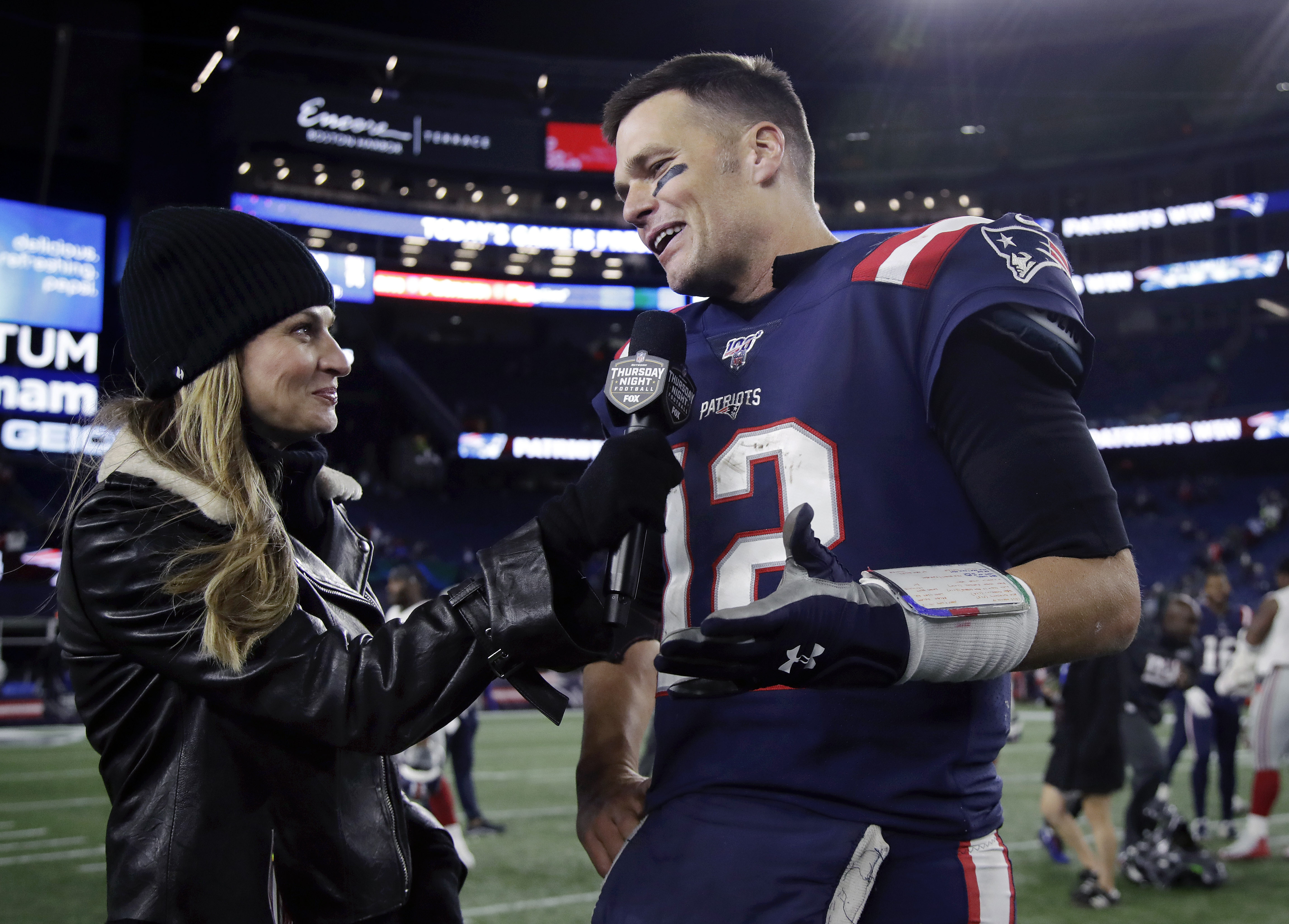 Fox Sports television sideline broadcast reporter Erin Andrews, left, interviews then-New England Patriots quarterback Tom Brady after a game Oct. 10, 2019, in Foxborough, Mass. Brady will join Fox sports as its lead football analyst once his playing career ends, the network said on Tuesday.