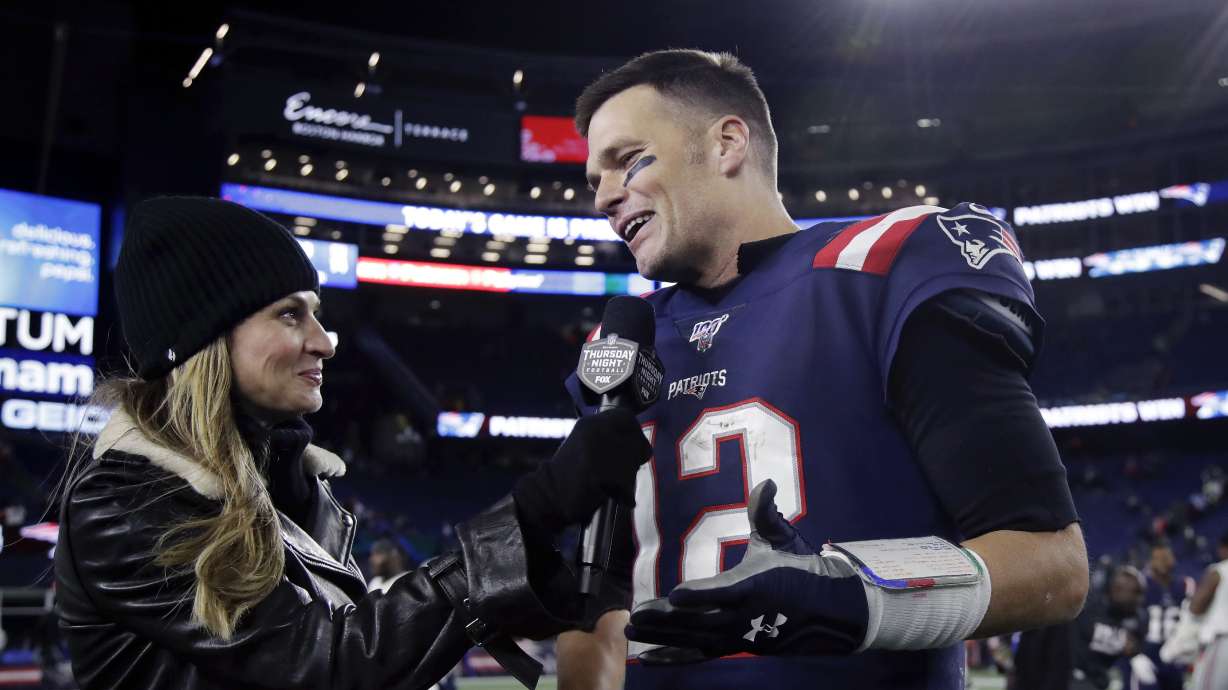 Fox Sports television sideline broadcast reporter Erin Andrews, left, interviews then-New England Patriots quarterback Tom Brady after a game Oct. 10, 2019, in Foxborough, Mass. Brady will join Fox sports as its lead football analyst once his playing career ends, the network said on Tuesday.