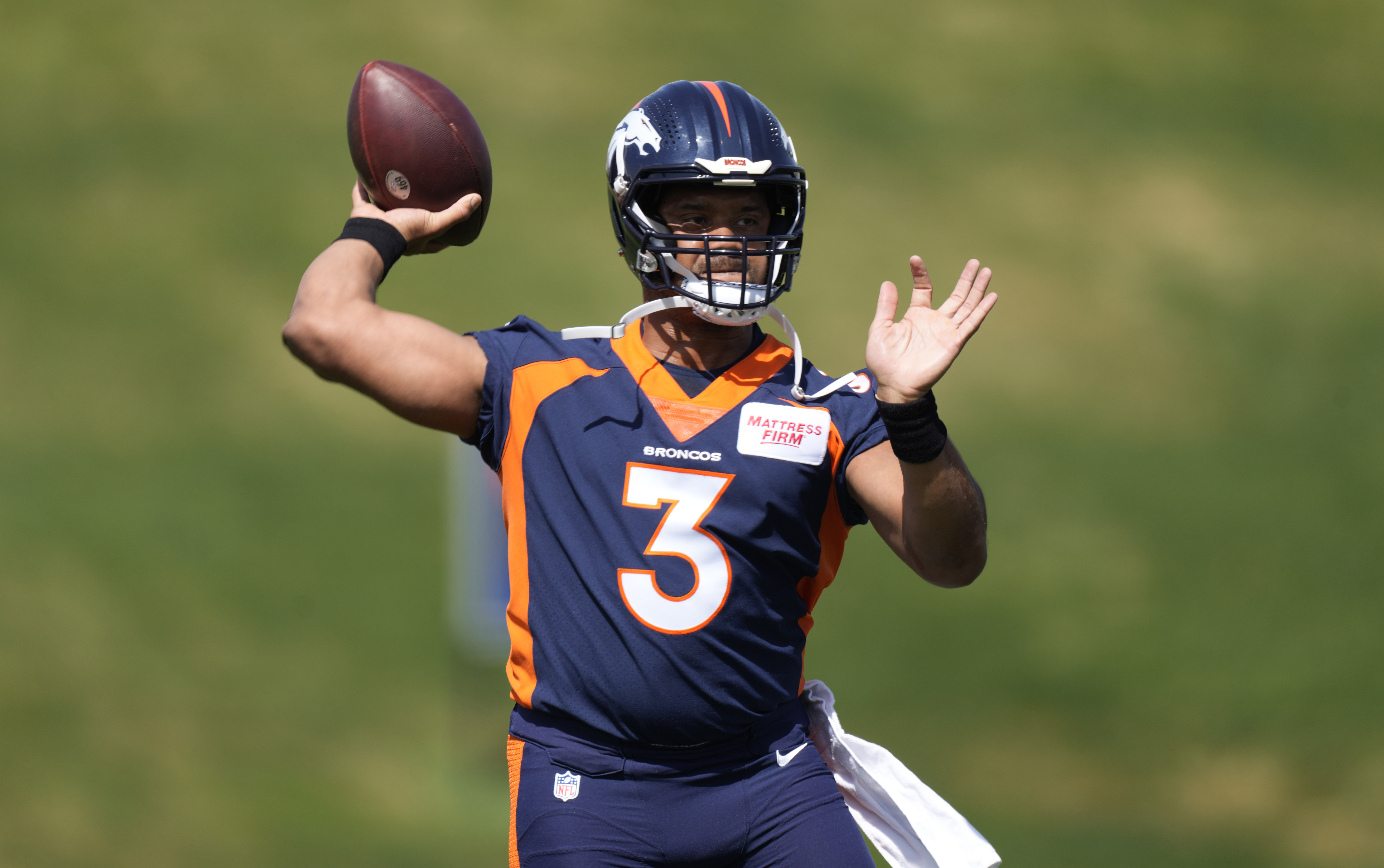 Denver Broncos quarterback Russell Wilson takes part in drills at the NFL football team's voluntary minicamp Wednesday, April 27, 2022, at the team's headquarters in Englewood, Colo. 