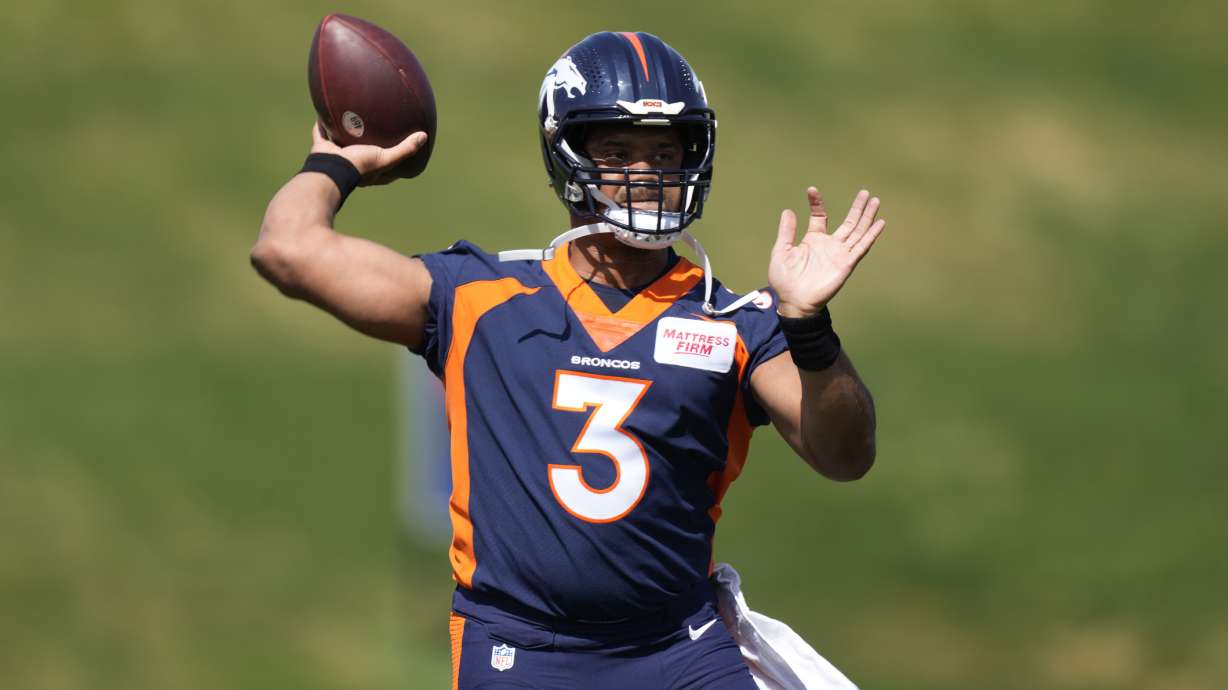 Denver Broncos quarterback Russell Wilson takes part in drills at the NFL football team's voluntary minicamp Wednesday, April 27, 2022, at the team's headquarters in Englewood, Colo.