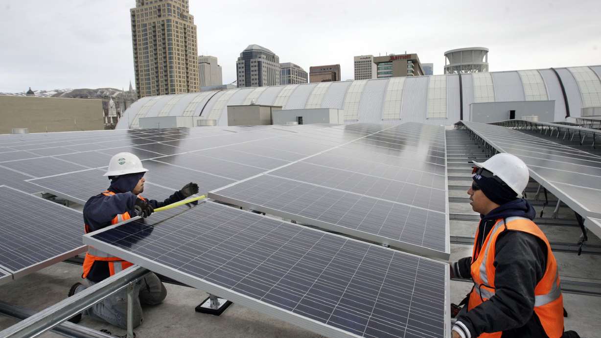 Antonio Urcino, right and Jose Perez install solar panels on the roof of the Salt Palace Convention Center in Salt Lake City on Feb. 1, 2012. Gov. Spencer Cox has unveiled the state’s new Energy and Innovation Plan that pursues an “all of the above” strategy and a commitment to American energy independence.