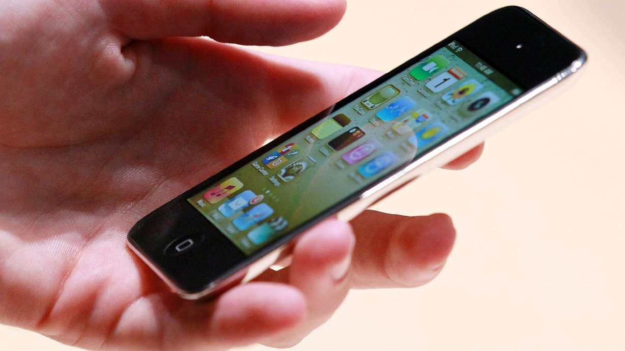 An Apple employee holds a new iPod Touch at an Apple Special Event at the Yerba Buena Center for the Arts on Sept. 1, 2010, in San Francisco. Apple said Tuesday it would discontinue production of the last iPod model it still sells, effectively bringing an end to the iconic product line that helped usher in a new era for the music industry and the tech giant.