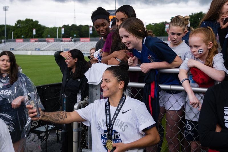 FILE PHOTO: May 7, 2022; Cary, NC, USA; North Carolina Courage midfielder Debinha (10) takes a selfie with a fan after defeating the Washington Spirit  at WakeMed Soccer Park.