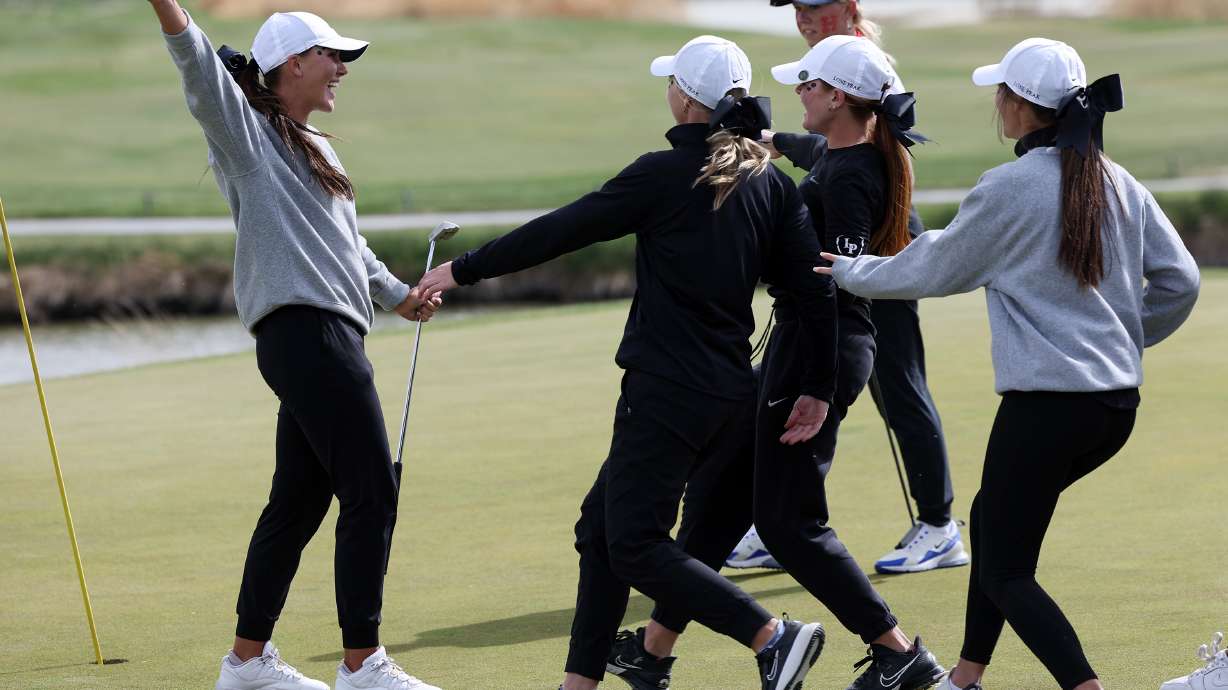Lone Peak's Berlin Long celebrates with her teammates as the Knights clinch the 6A golf championship at Stonebridge Golf Club in West Valley City on Tuesday, May 10, 2022.