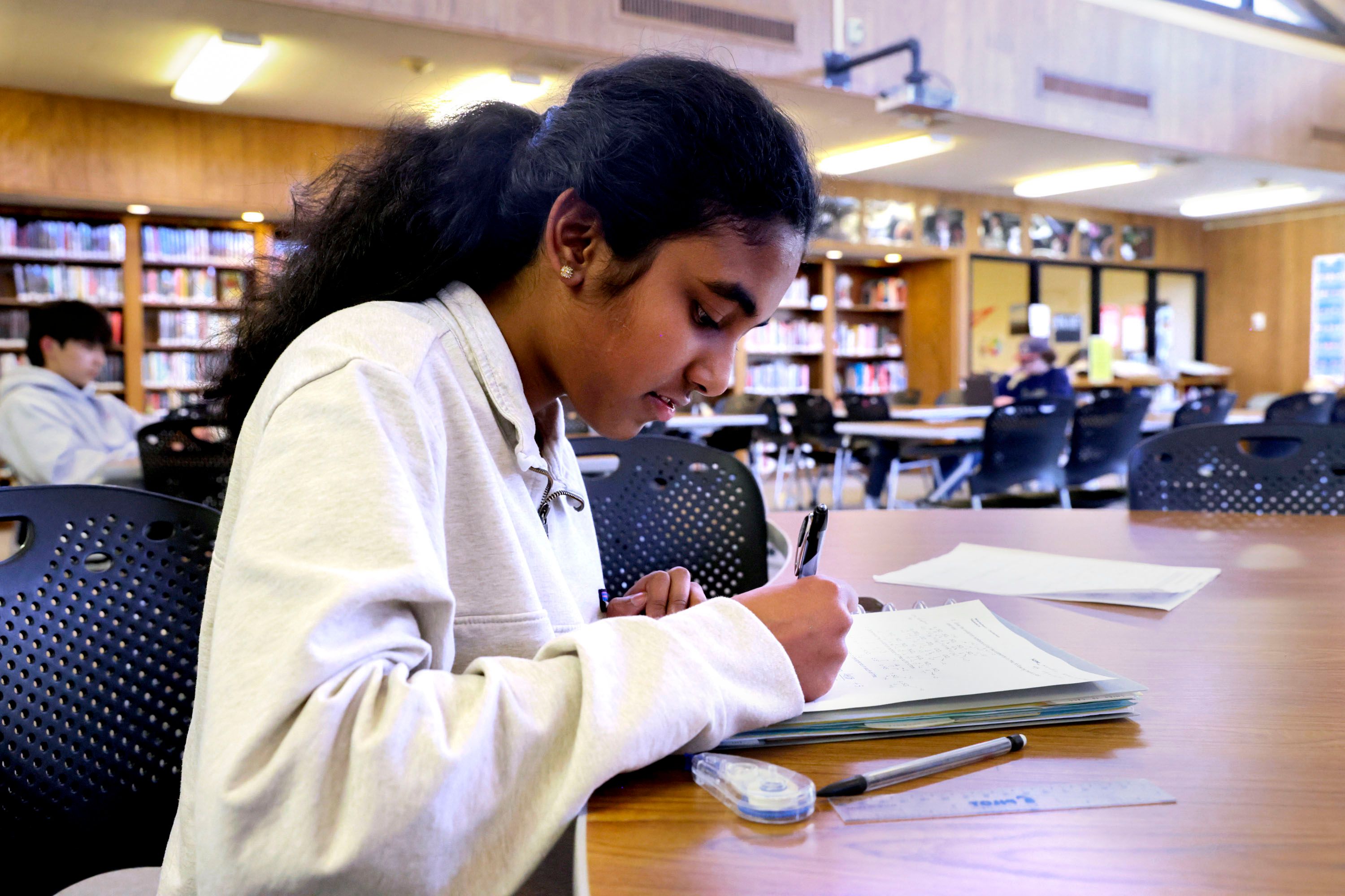 Nandhini Ramanathan, a junior at Skyline High School, does her homework at the library at Skyline High School in Salt Lake City on Tuesday. The Utah State Board of Education is working on a policy intended to provide school boards with a framework to create or update library policies.