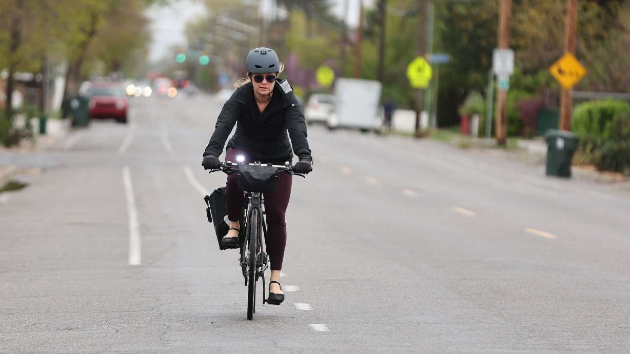 Jen Oxborrow rides her bicycle to work in Salt Lake City on May 3. The Salt Lake City Council approved an ordinance reducing the speed limit on 70% of city streets to 20 mph. They say the measure can help reduce serious injuries or deaths.
