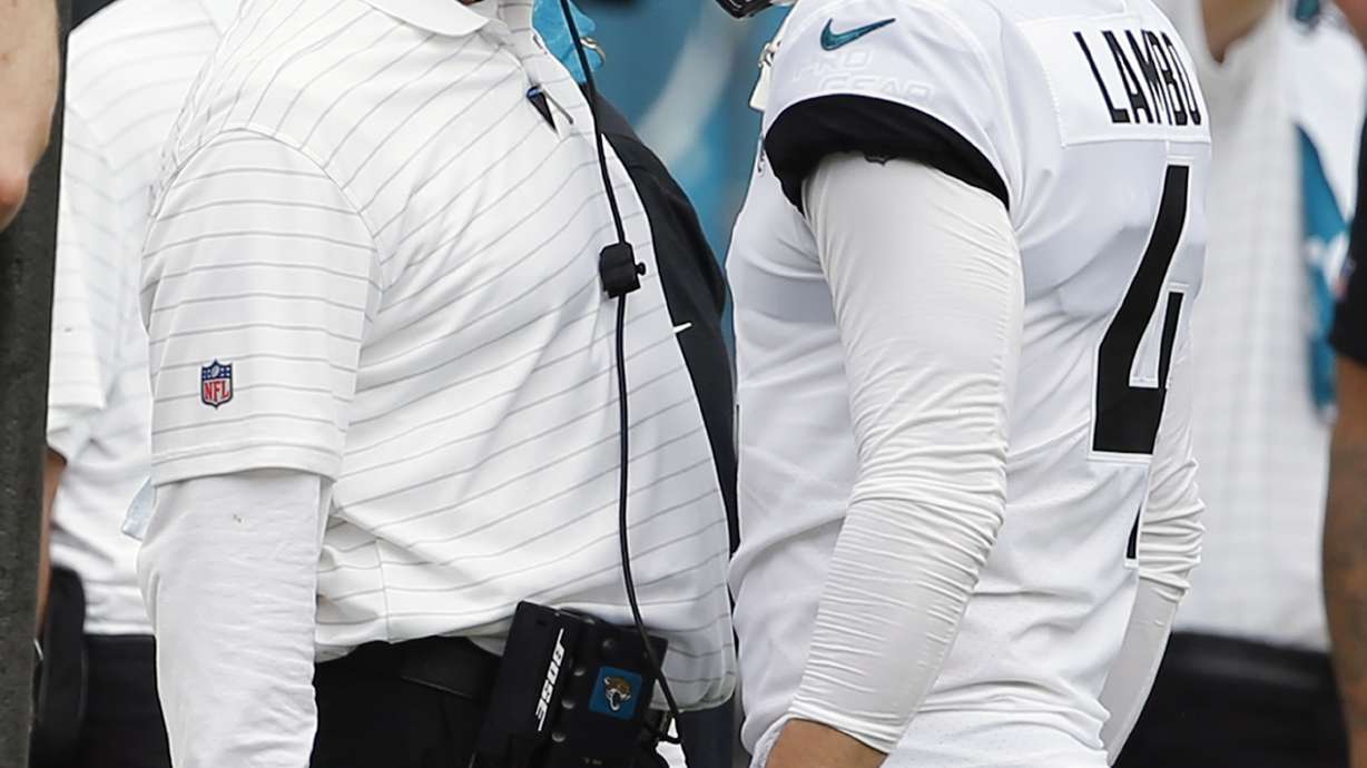 FILE - Jacksonville Jaguars head coach Urban Meyer, left, talks with place kicker Josh Lambo after Lambo missed his second field goal against the Denver Broncos during the first half of an NFL football game, Sunday, Sept. 19, 2021, in Jacksonville, Fla. Former NFL place-kicker Josh Lambo has filed a lawsuit Tuesday, May 10, 2022 against the Jacksonville Jaguars seeking more than $3.5 million in salary and damages for emotional distress caused by former head coach Urban Meyer.