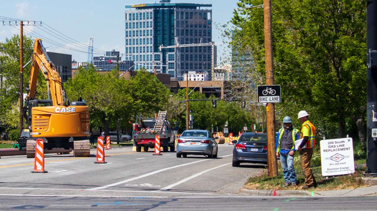 Construction crews work to replace Dominion Energy gas lines on 200 South in Salt Lake City Wednesday. Transportation crews will replace the roadway above the lines throughout the summer as a part of revamping the street.