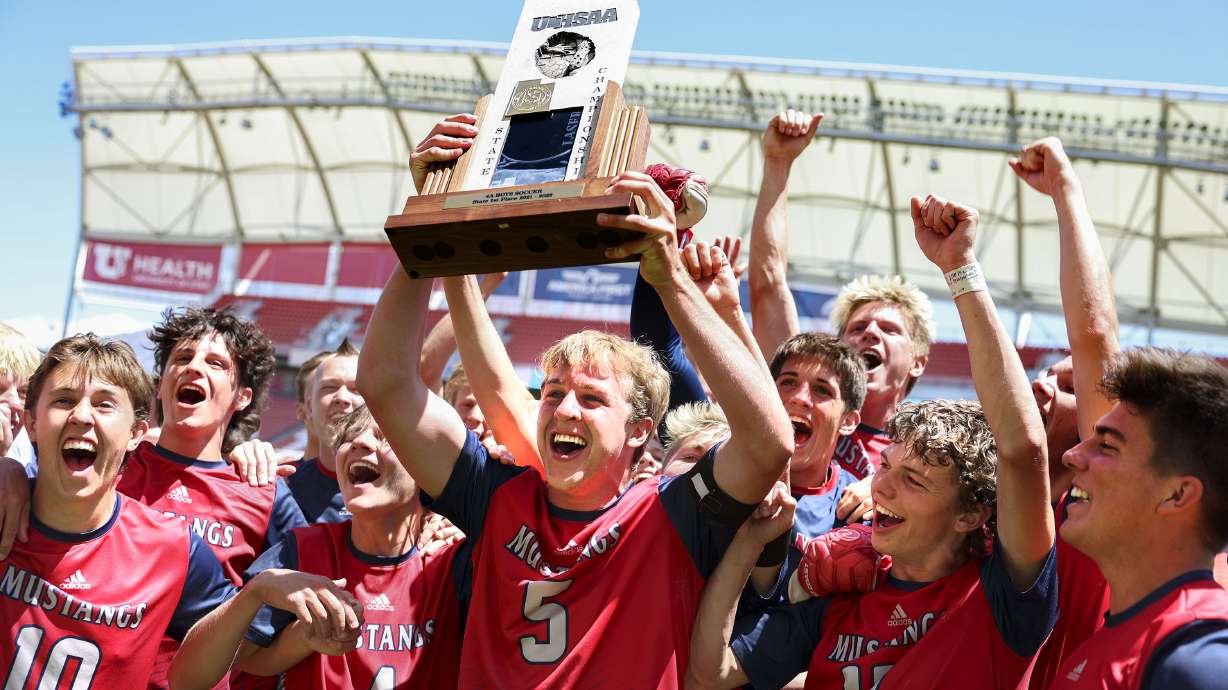 Crimson Cliffs players celebrates their 4A boys soccer championship win against Ridgeline at Rio Tinto Stadium in Sandy on Wednesday, May 11, 2022.