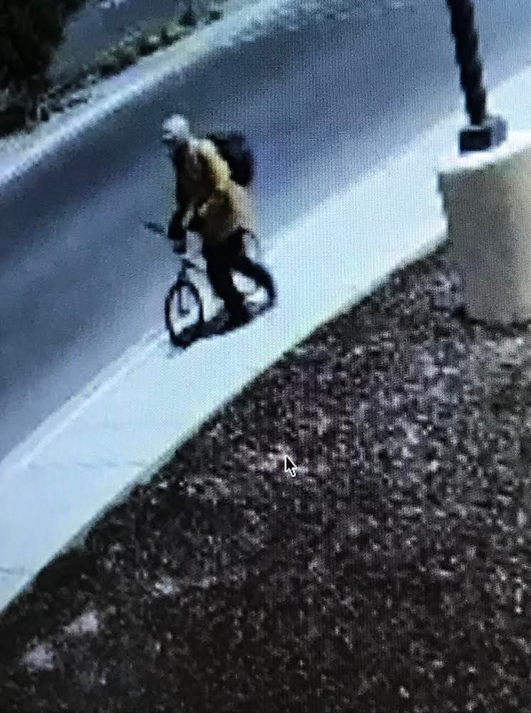 On Wednesday, South Salt Lake police announced they were looking for a person whose image was captured in surveillance footage at the scene. The blurry photo shows a person wearing a tan-colored jacket or shirt, a hoodie or helmet and a dark-colored backpack, and walking with a bicycle.