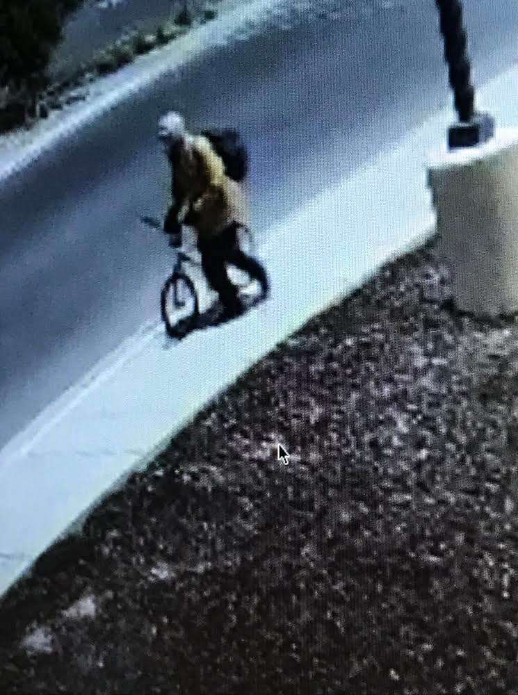 On Wednesday, South Salt Lake police announced they were looking for a person whose image was captured in surveillance footage at the scene. The blurry photo shows a person wearing a tan-colored jacket or shirt, a hoodie or helmet and a dark-colored backpack, and walking with a bicycle.