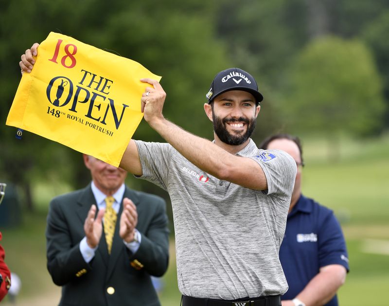 FILE PHOTO: Jun 9, 2019; Hamilton, Ontario, CAN; Adam Hadwin poses with a flag from the Open after finishing sixth at the 2019 RBC Canadian Open golf tournament at Hamilton Golf & Country Club. Hadwin earns an entry to the Open with the finish.